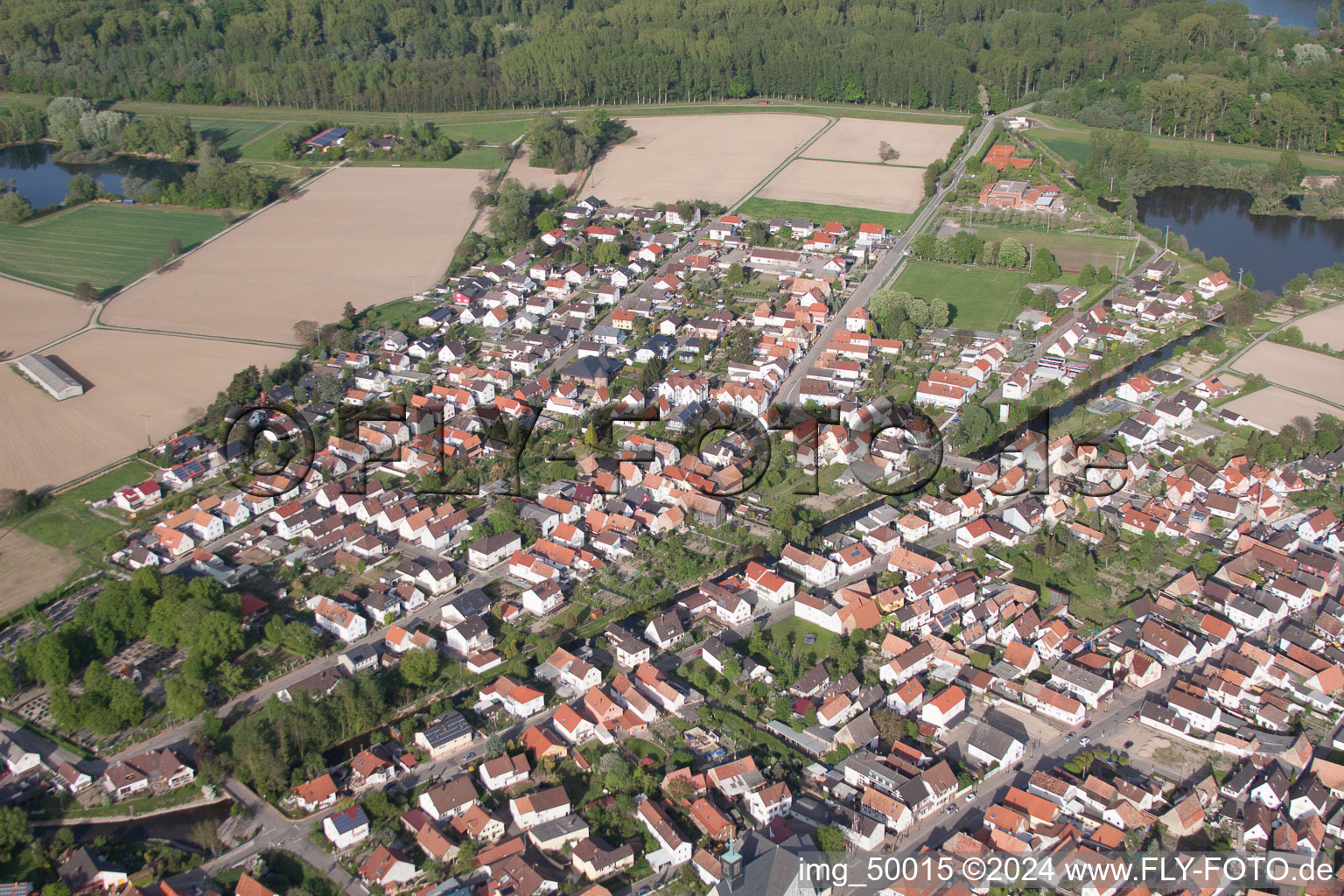 Aerial view of Village - view on the edge of agricultural fields and farmland in Leimersheim in the state Rhineland-Palatinate