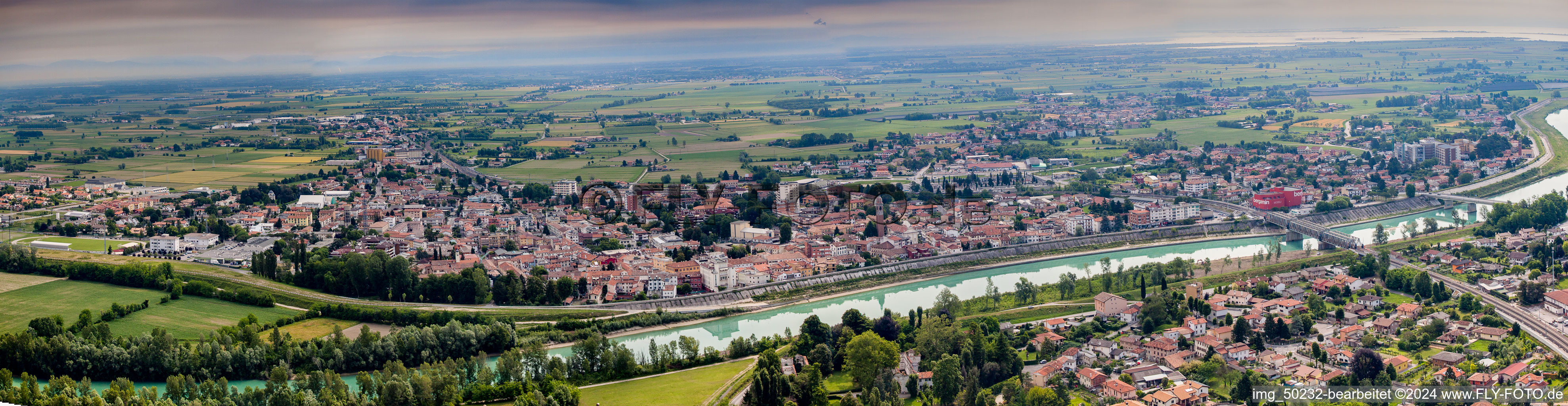 Panoramic perspective City center in the downtown area on the banks of river course of Tagliamento in Latisana in Friuli-Venezia Giulia, Italy
