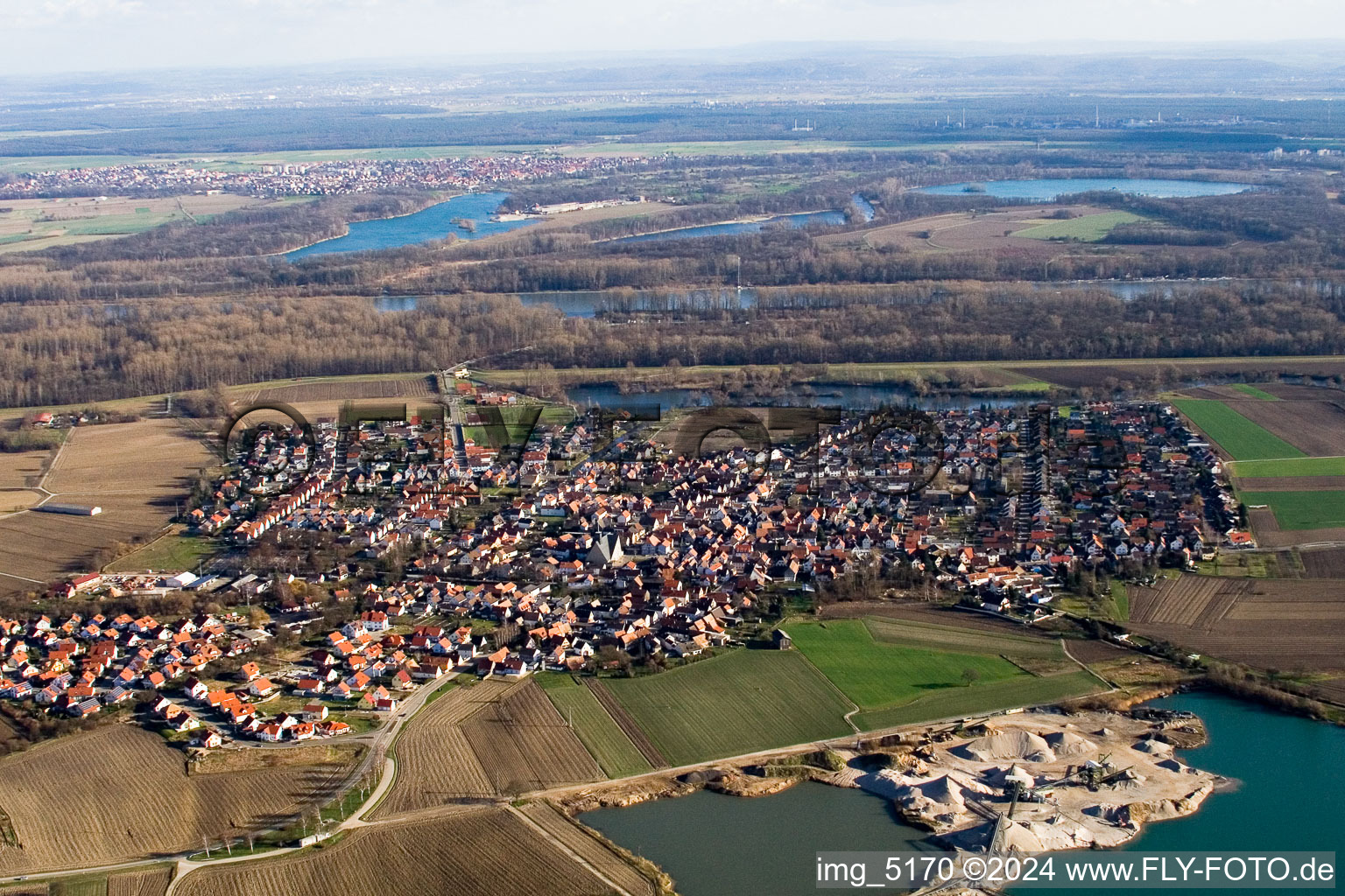 Oblique view of Village - view on the edge of agricultural fields and farmland in Leimersheim in the state Rhineland-Palatinate