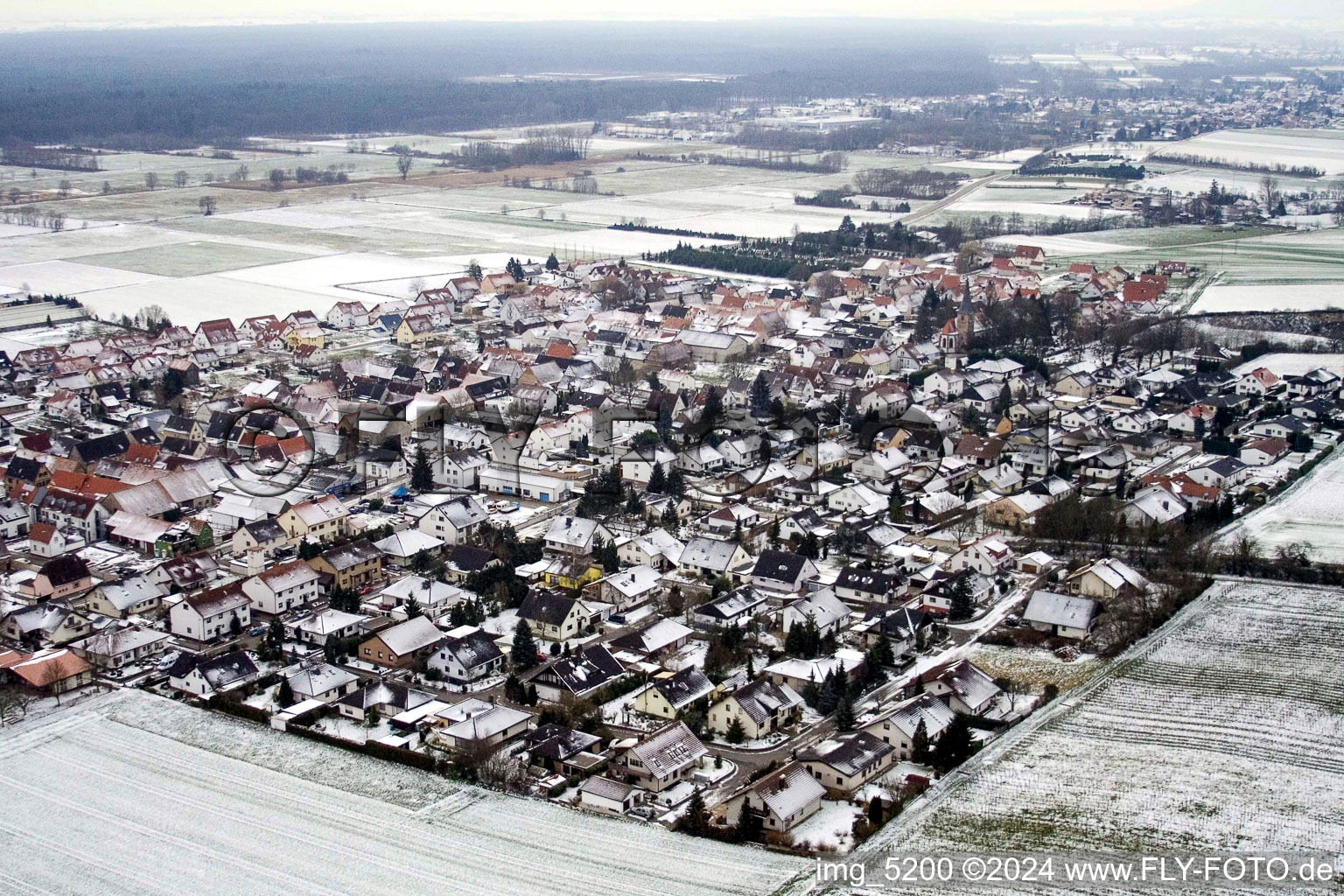 Wintry snowy Village - view on the edge of agricultural fields and farmland in Freckenfeld in the state Rhineland-Palatinate