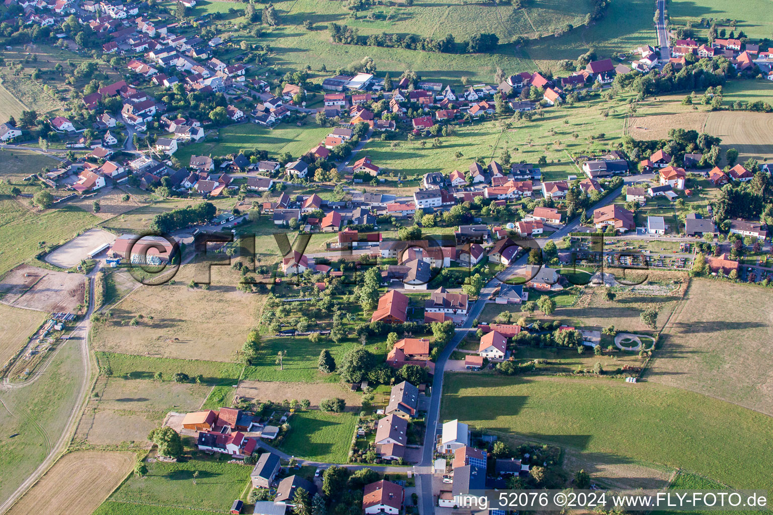 Oblique view of Village - view on the edge of agricultural fields and farmland in Wuerzberg in the state Hesse, Germany