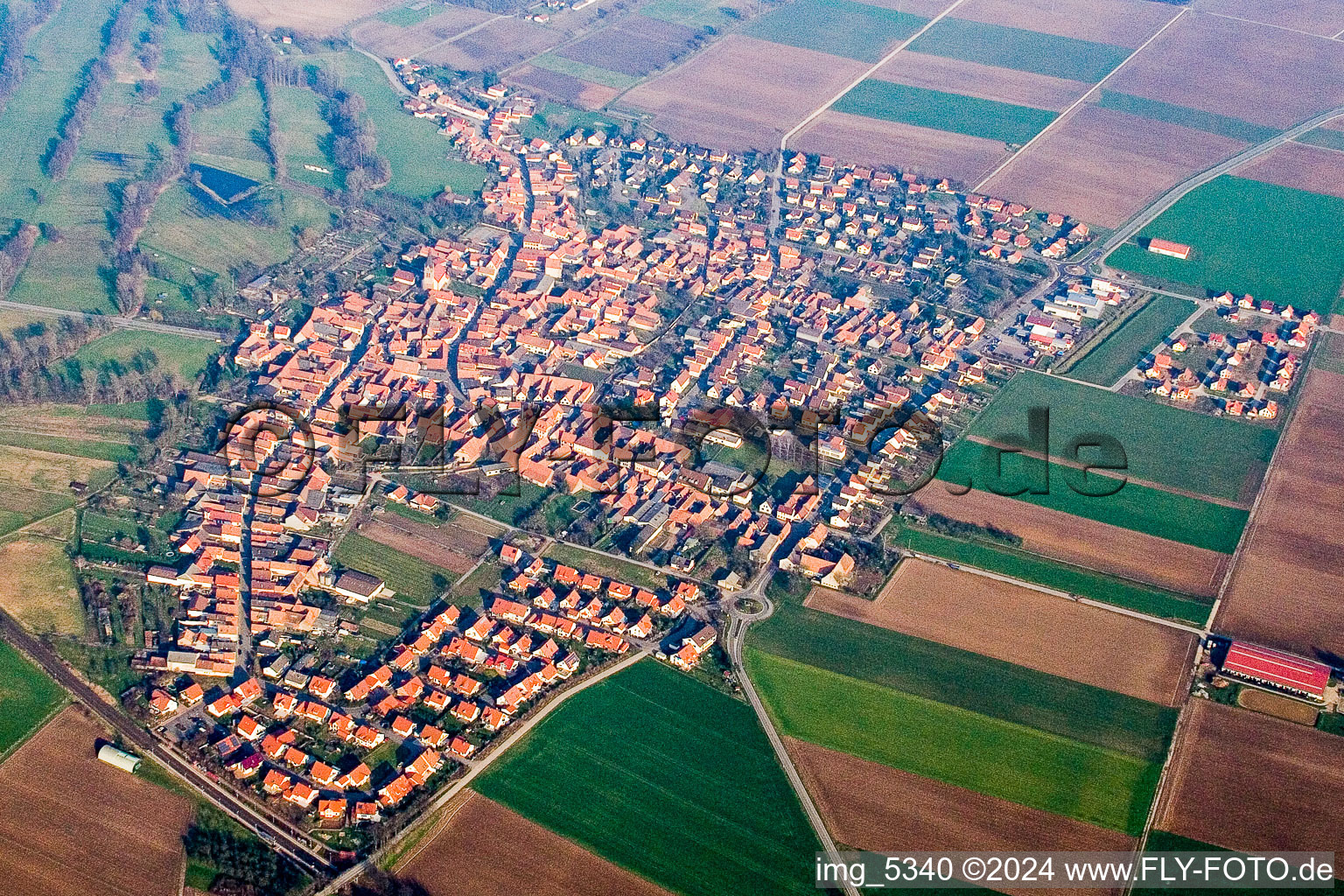 Aerial view of Village - view on the edge of agricultural fields and farmland in Steinweiler in the state Rhineland-Palatinate