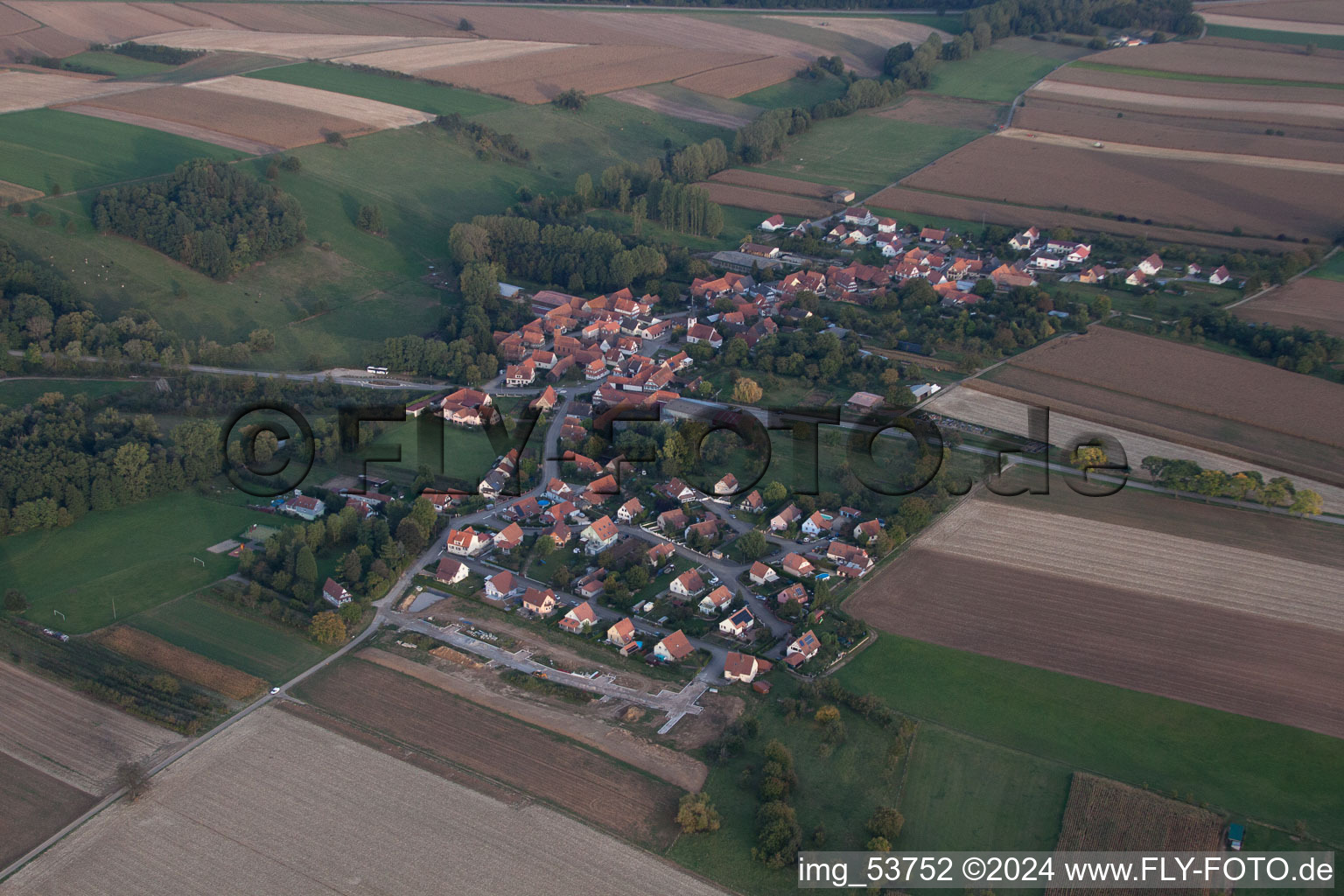 Village - view on the edge of agricultural fields and farmland in Ingolsheim in Grand Est, France