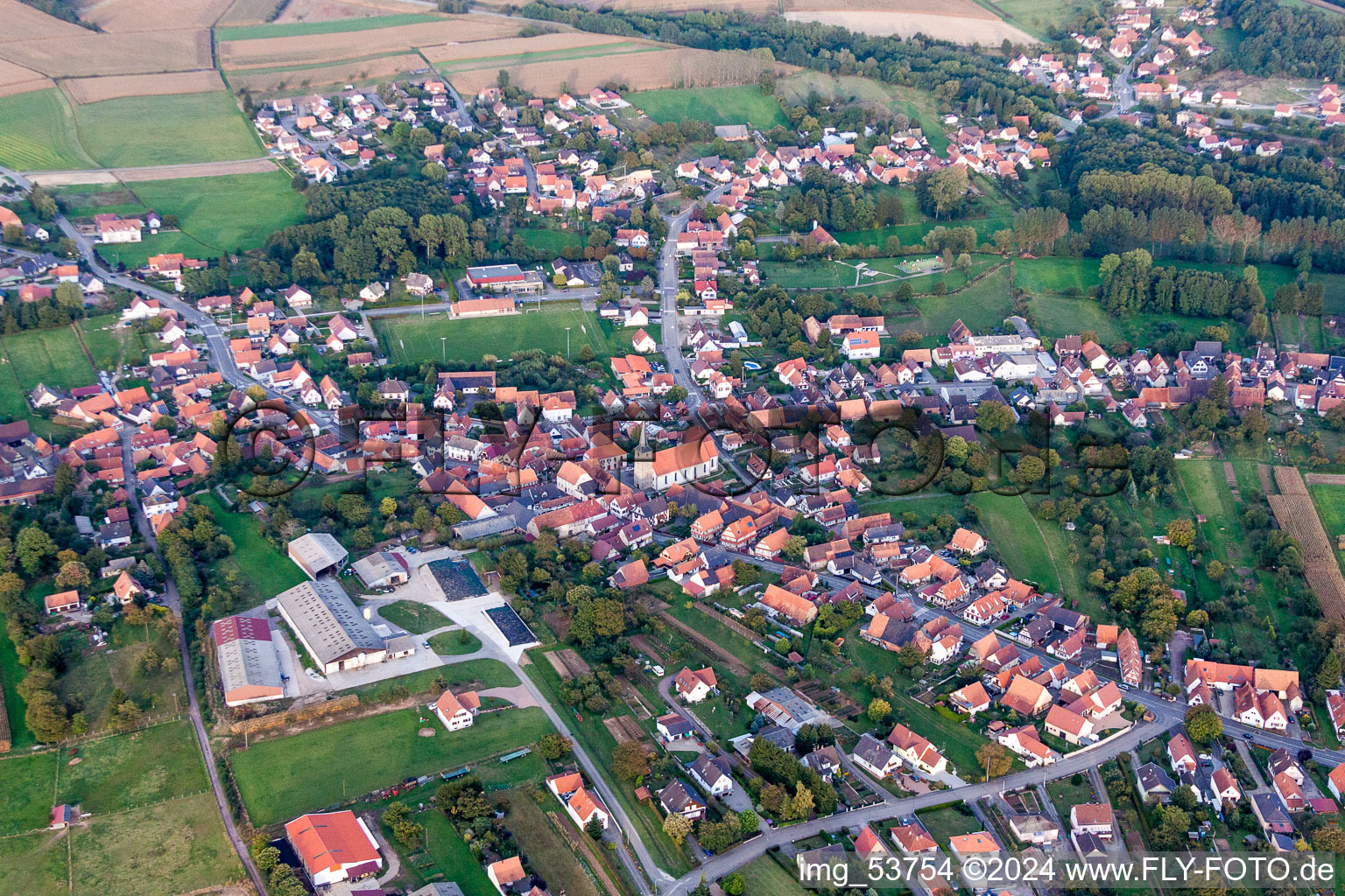 Village - view on the edge of agricultural fields and farmland in Riedseltz in Grand Est, France from above