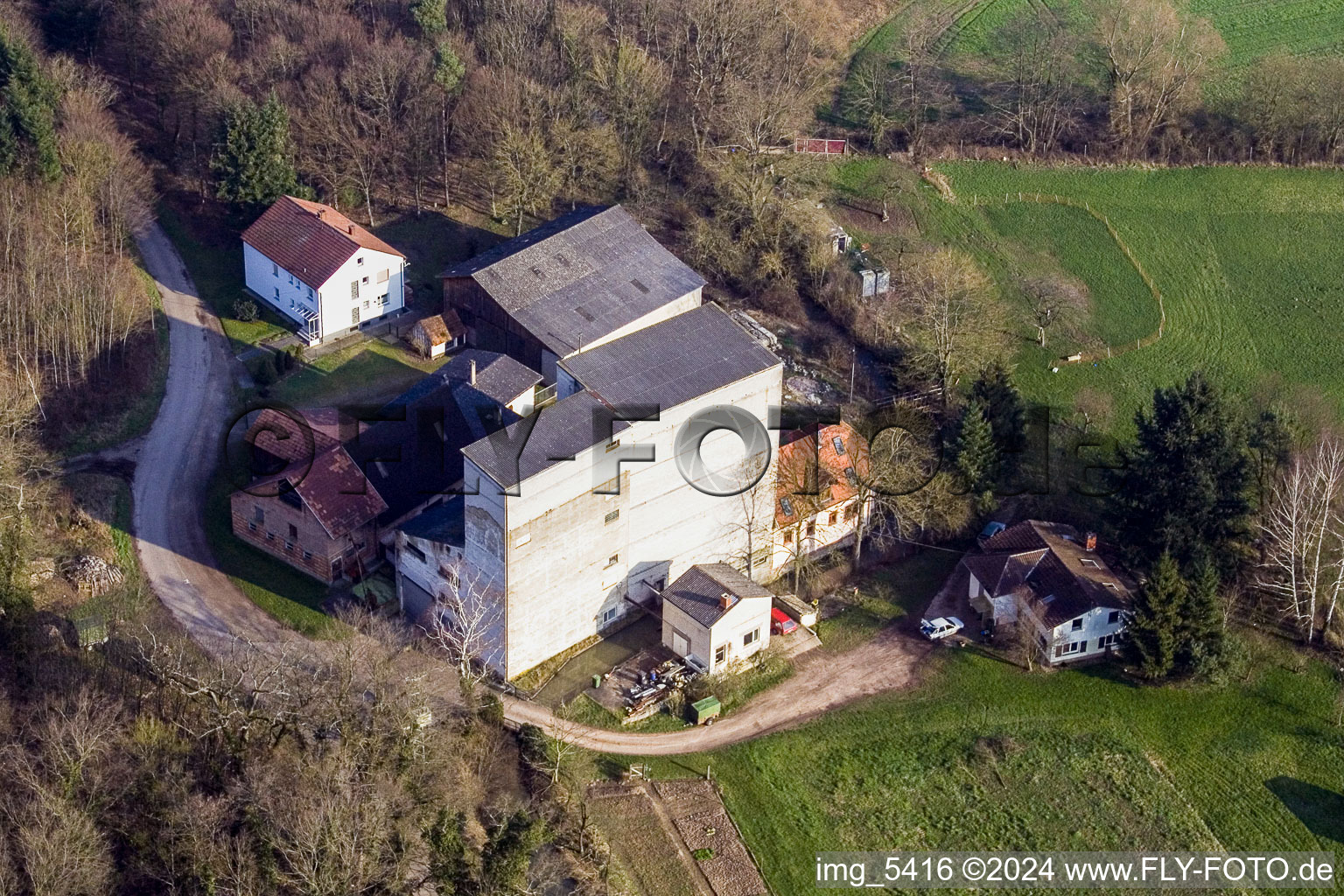 Historic water mill on the farmstead of a farm between forest and meadows in Minfeld in the state Rhineland-Palatinate, Germany