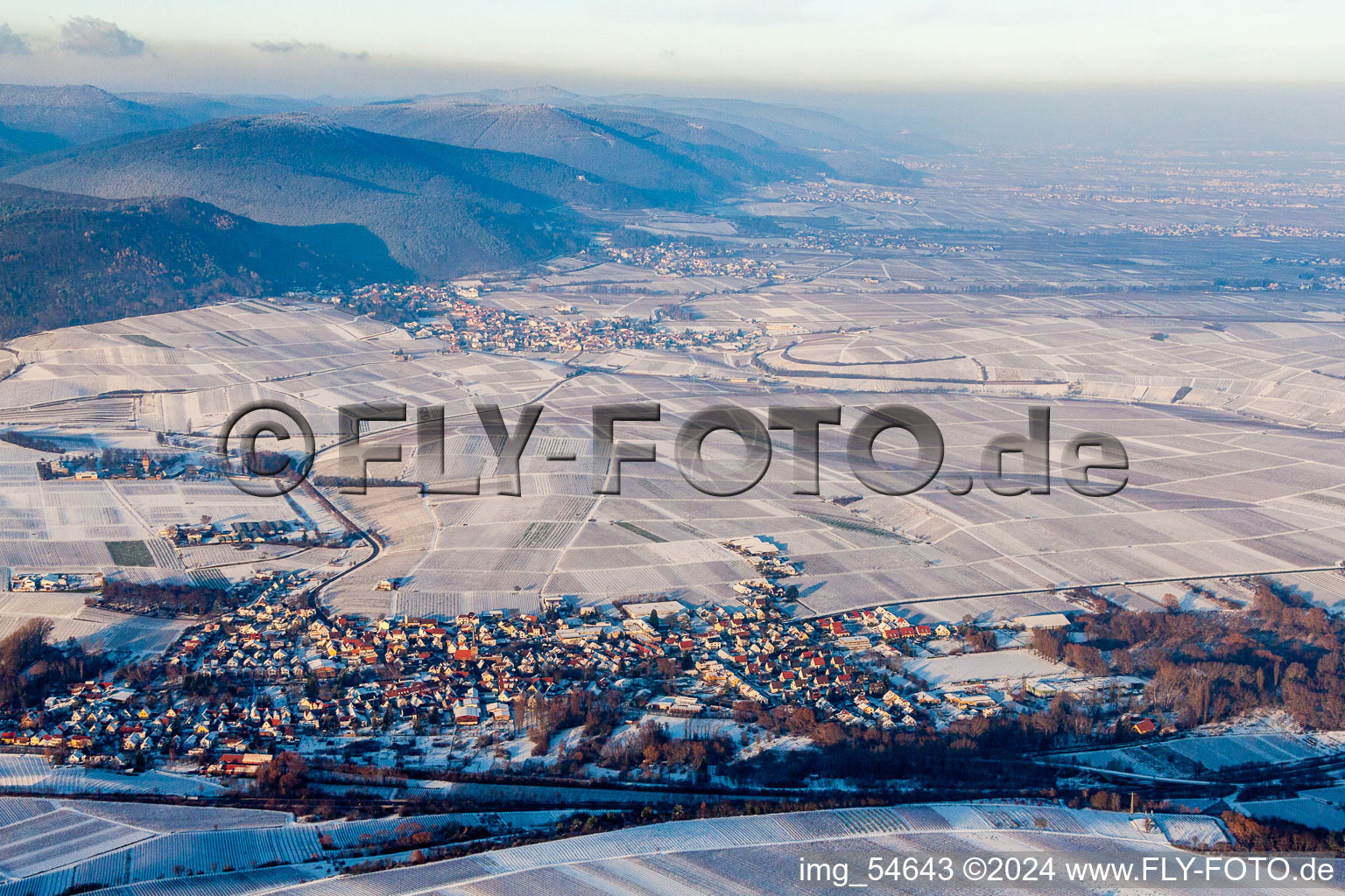 Aerial view of Wintry snowy Town View of the streets and houses of the residential areas in Siebeldingen in the state Rhineland-Palatinate, Germany