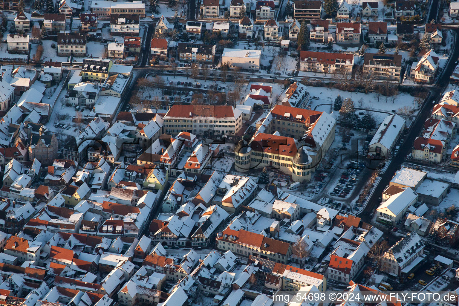 Wintry snowy townscape with streets and houses of the residential areas in Bad Bergzabern in the state Rhineland-Palatinate from above