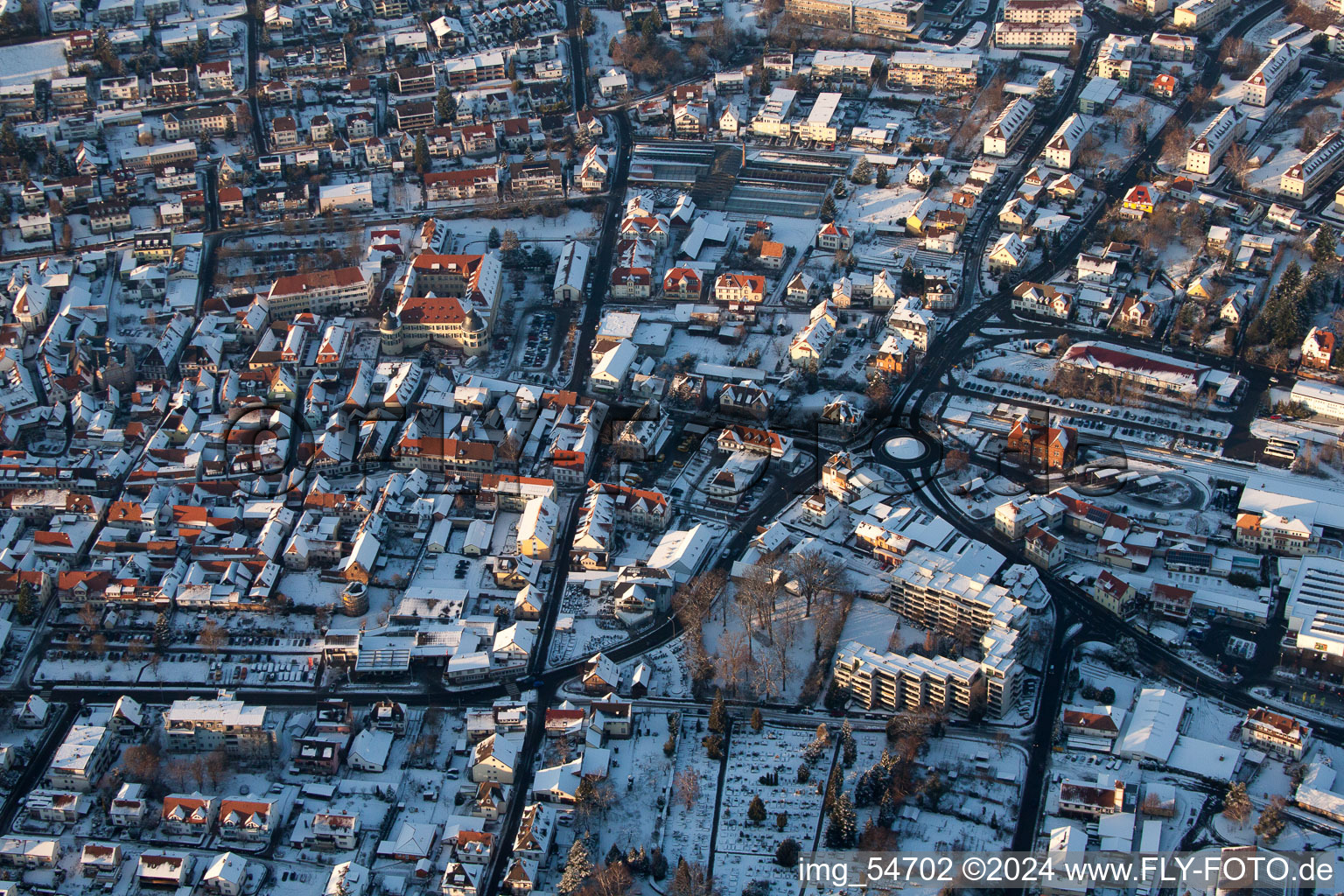 Wintry snowy townscape with streets and houses of the residential areas in Bad Bergzabern in the state Rhineland-Palatinate out of the air