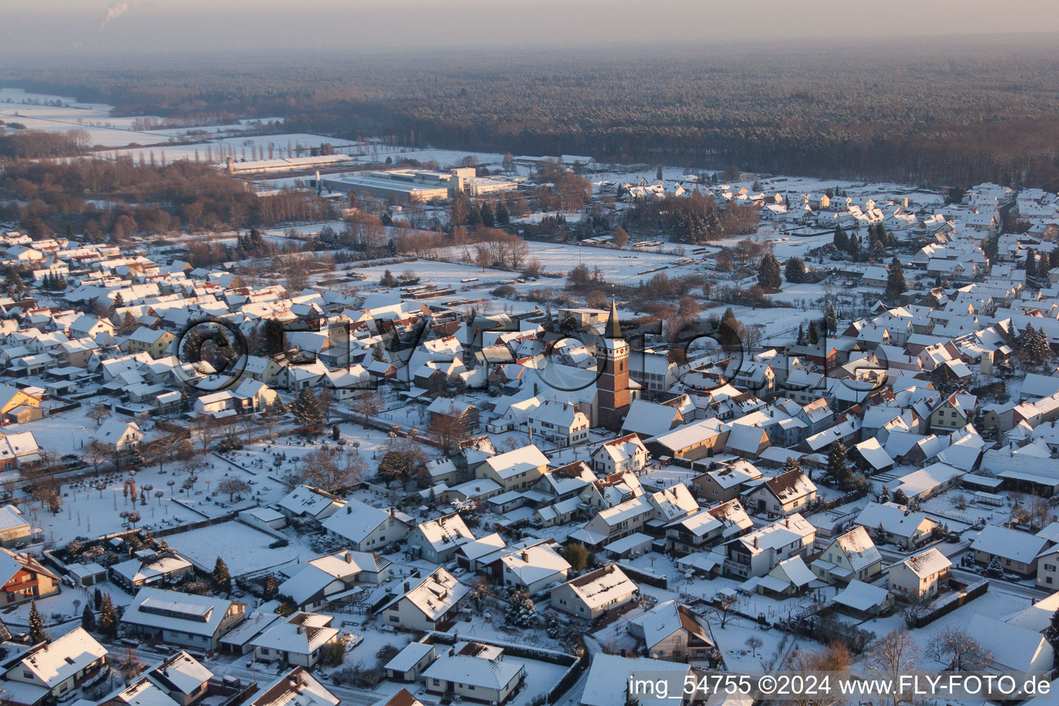 Aerial view of Wintry snowy Church building in the village of in the district Schaidt in Woerth am Rhein in the state Rhineland-Palatinate, Germany
