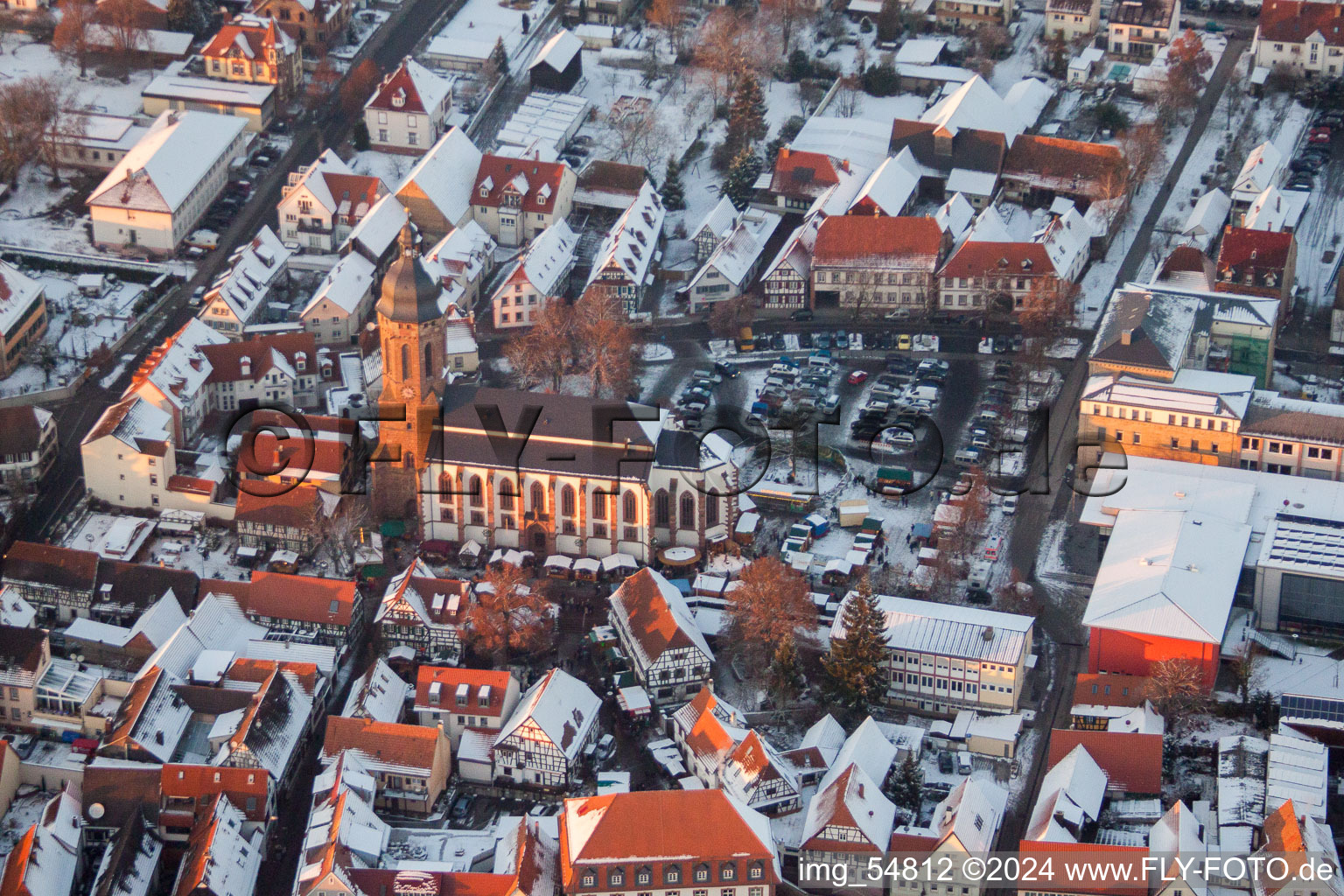 Wintry snowy Church building in of Sankt Georgskirche, town-hall and primary school in Old Town- center of downtown in Kandel in the state Rhineland-Palatinate, Germany