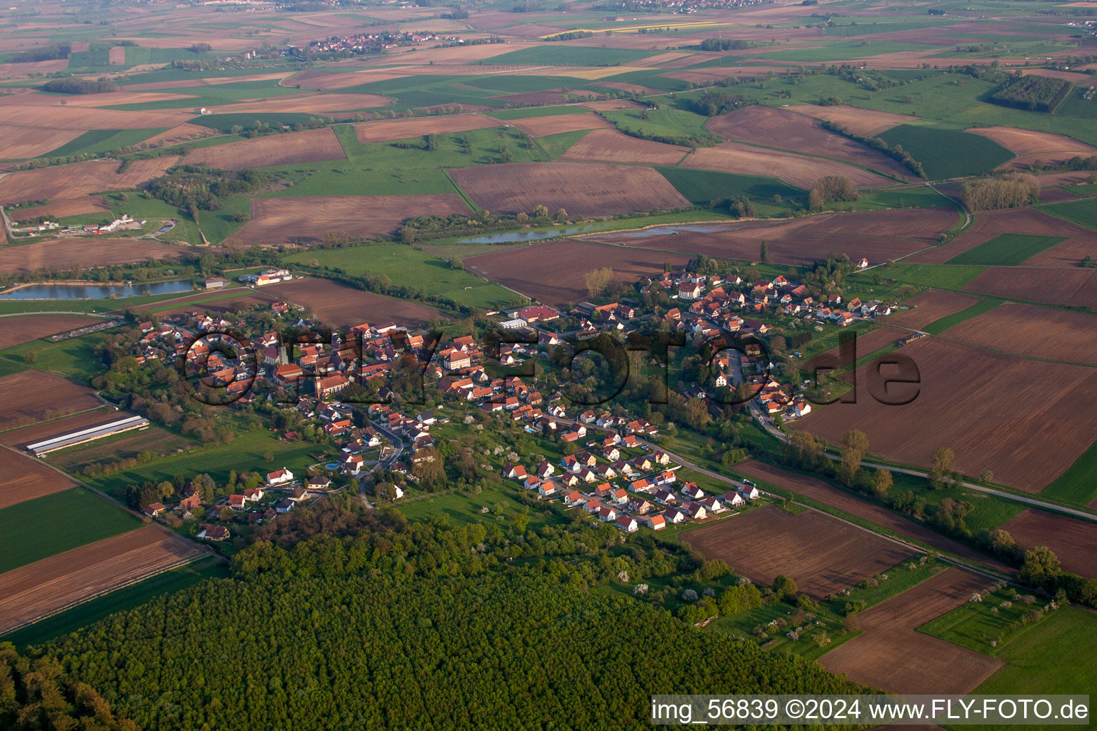 Aerial view of Village - view on the edge of agricultural fields and farmland in Kutzenhausen in Grand Est, France