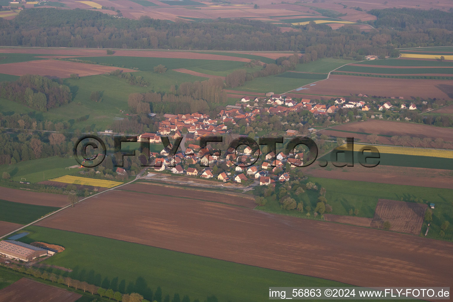 Aerial view of Village - view on the edge of agricultural fields and farmland in Ingolsheim in Grand Est, France