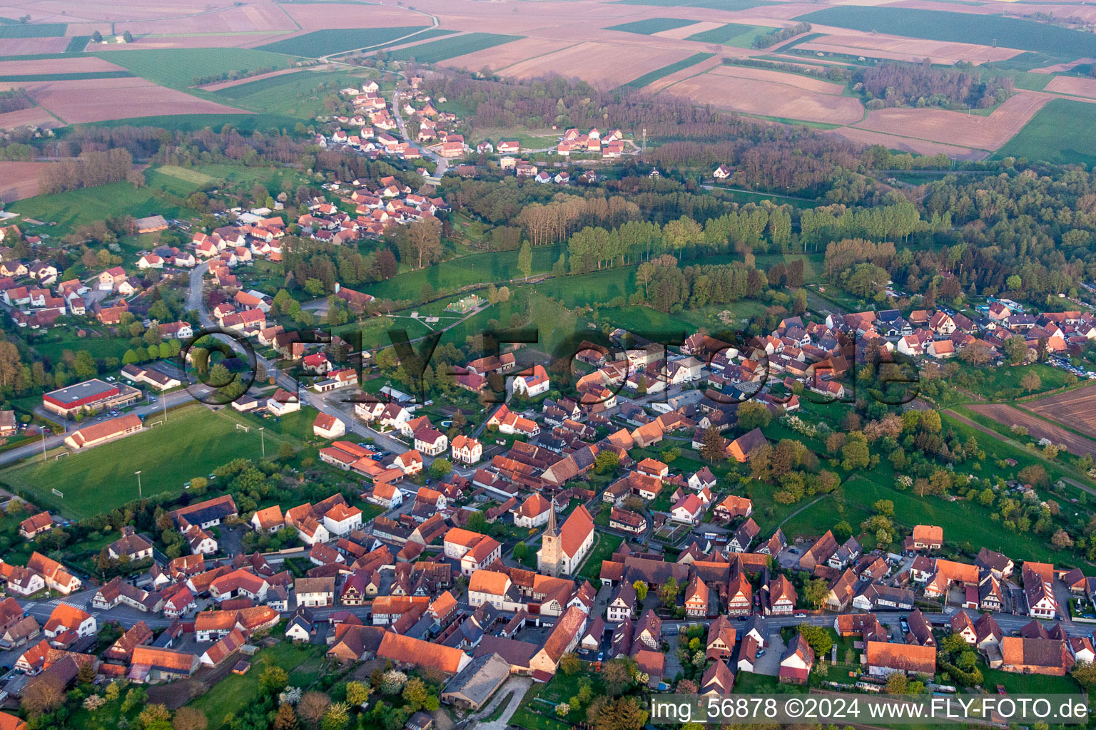 Village - view on the edge of agricultural fields and farmland in Riedseltz in Grand Est, France out of the air