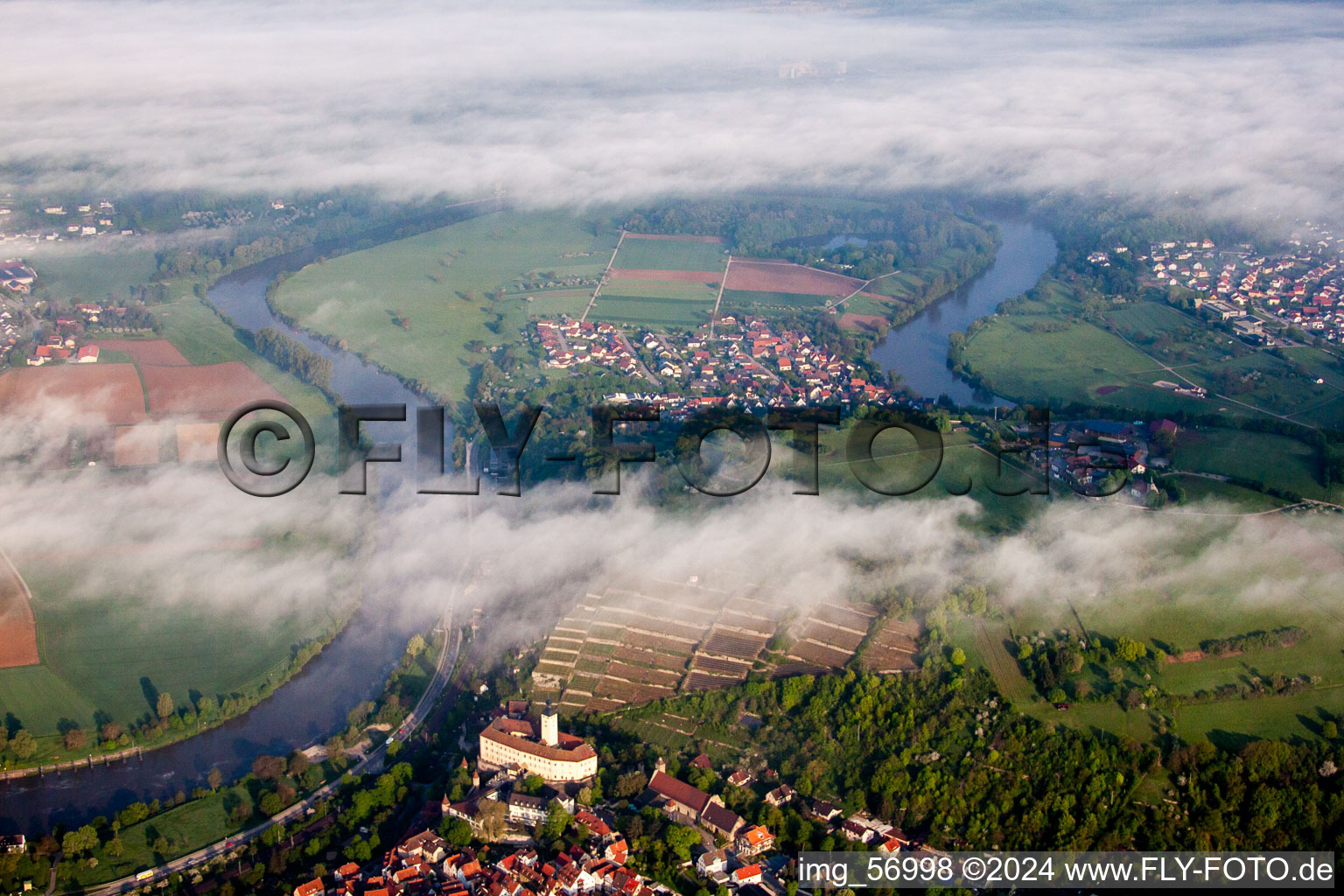 Aerial view of Castle of Schloss Horneck between clouds in Gundelsheim in the state Baden-Wurttemberg