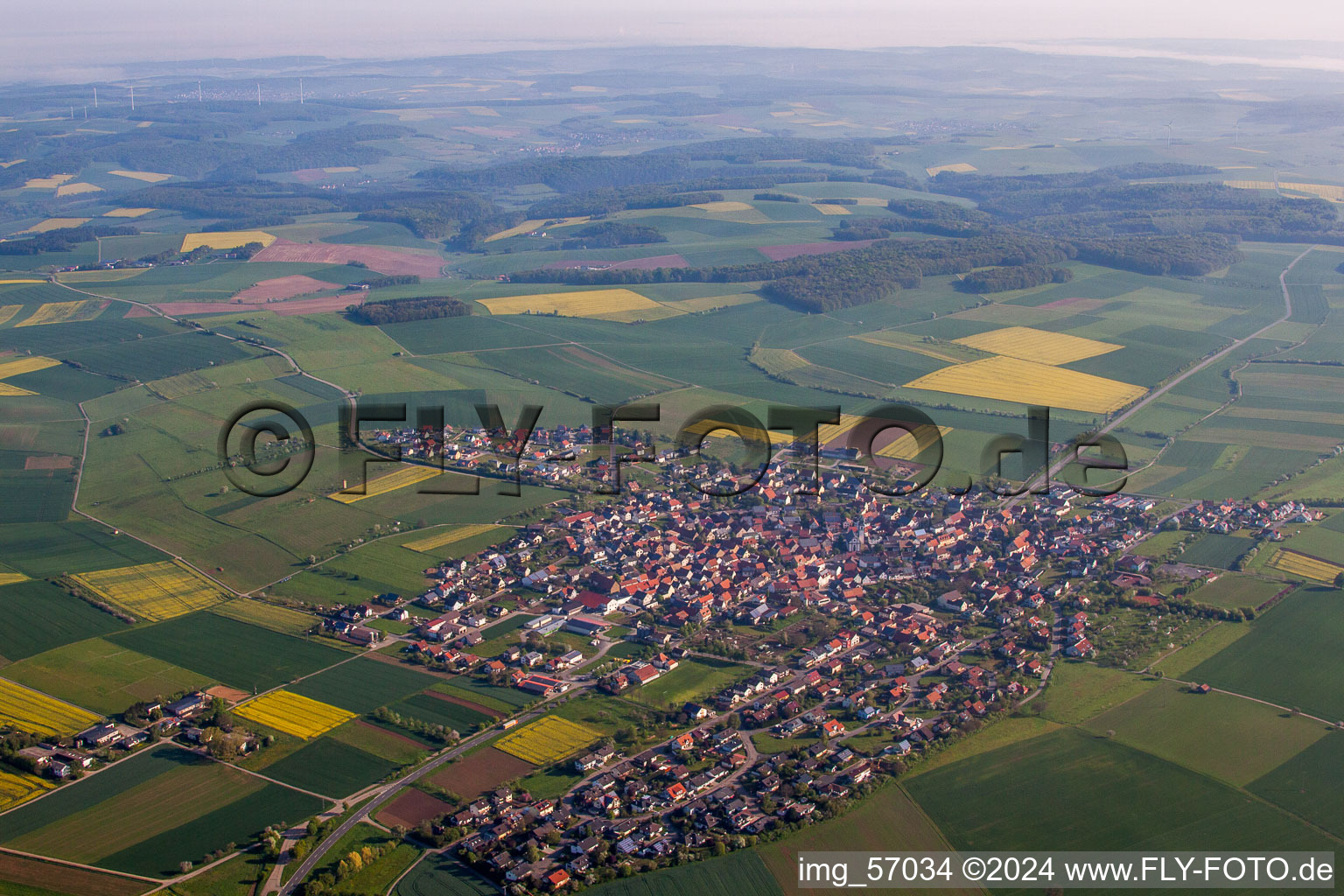Village - view on the edge of agricultural fields and farmland in Kleinrinderfeld in the state Bavaria, Germany