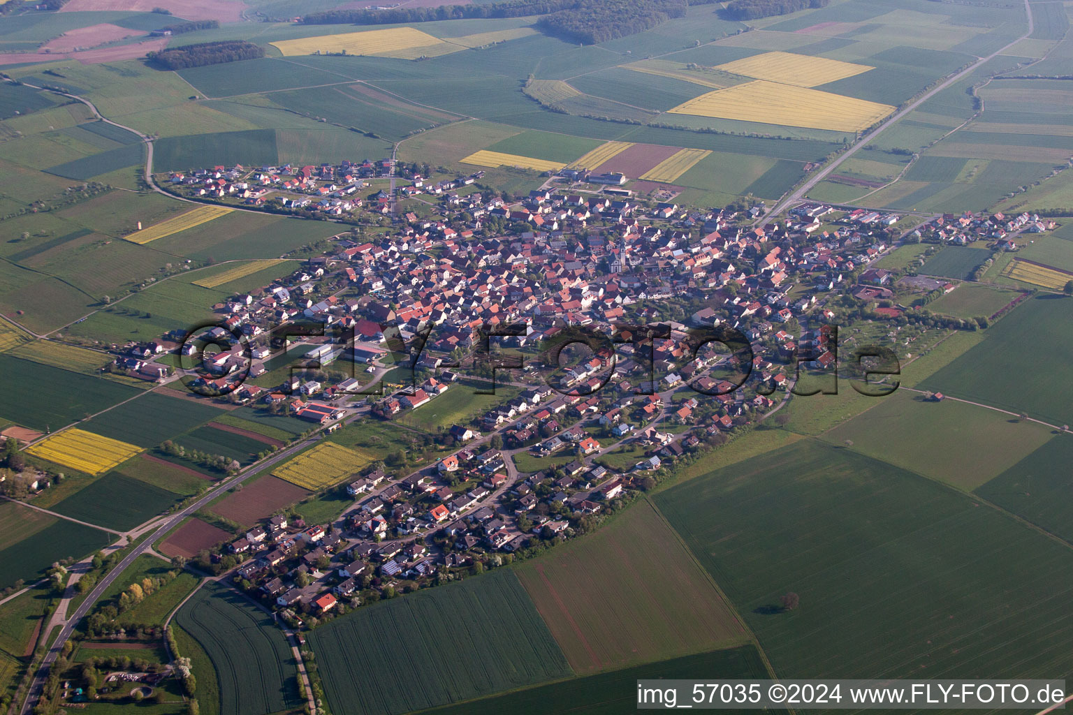 Aerial view of Village - view on the edge of agricultural fields and farmland in Kleinrinderfeld in the state Bavaria, Germany
