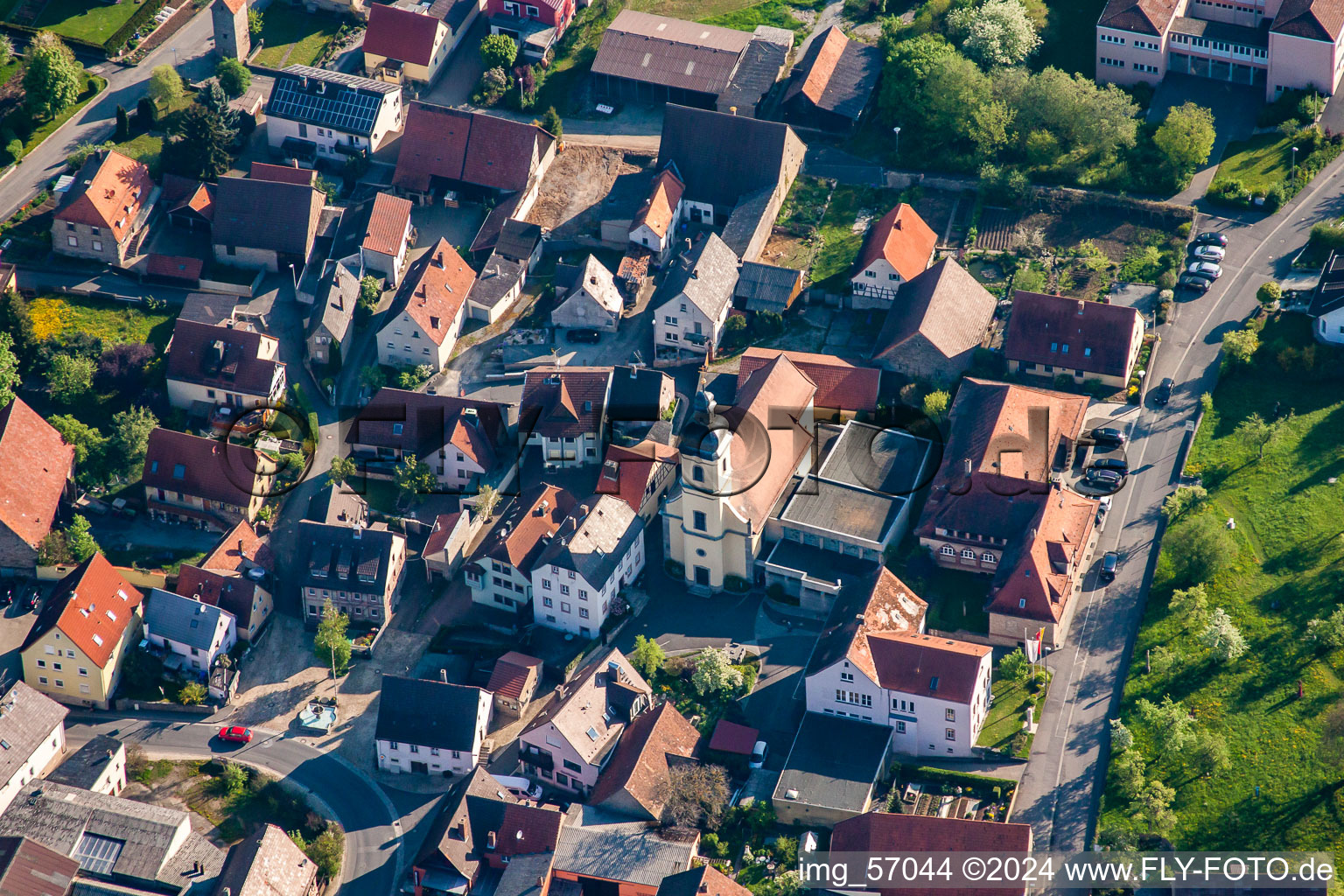 Aerial photograpy of Village - view on the edge of agricultural fields and farmland in Kleinrinderfeld in the state Bavaria, Germany