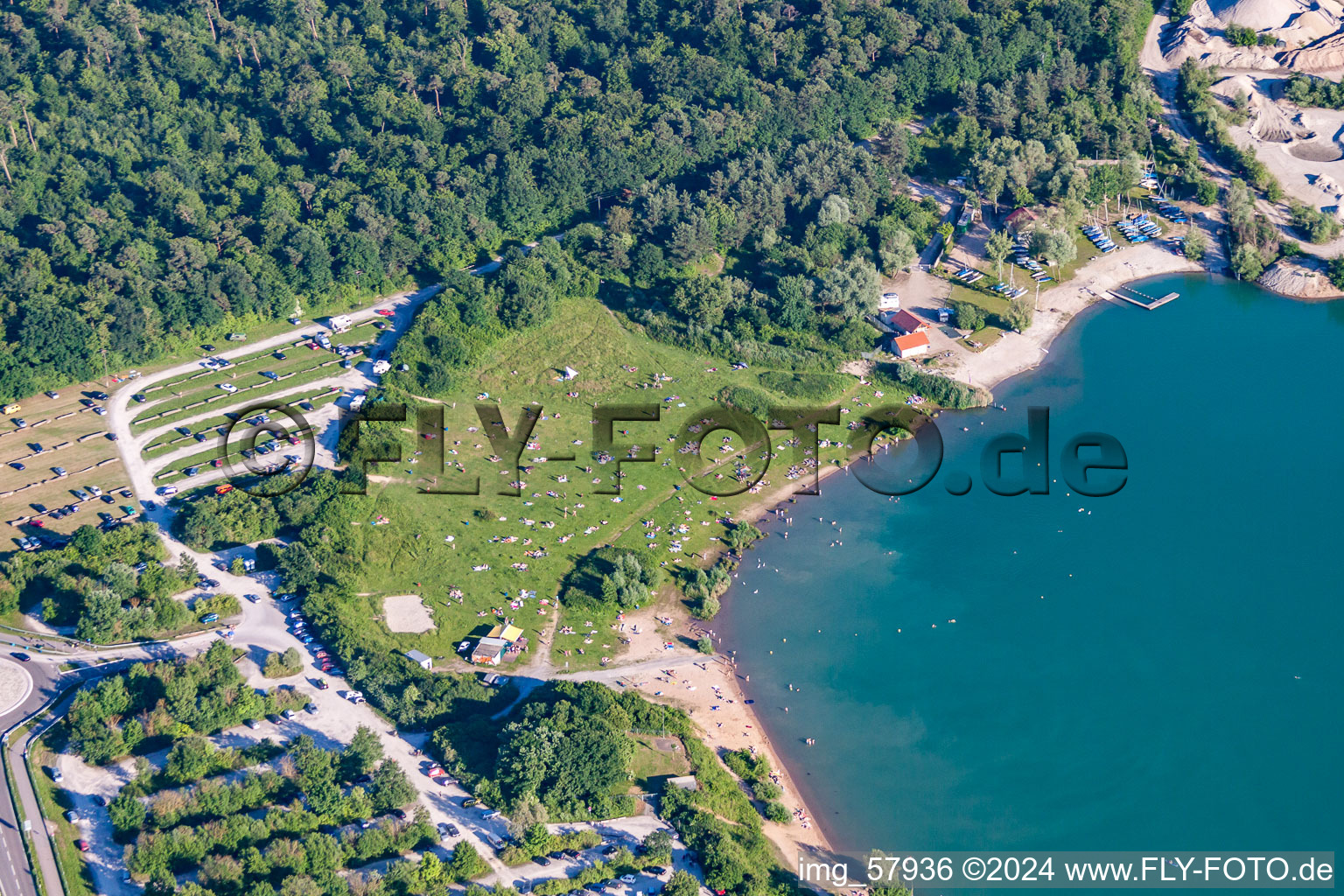 Aerial view of Mass influx of nudist bathers on the beach and the shore areas of the lake Epplesee in Rheinstetten in the state Baden-Wurttemberg, Germany