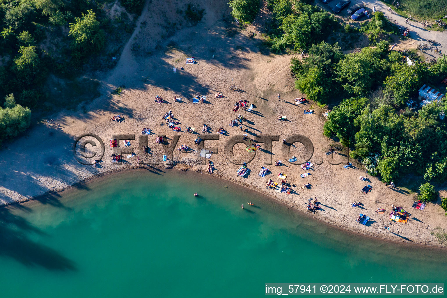 Aerial photograpy of Mass influx of nudist bathers on the beach and the shore areas of the lake Epplesee in Rheinstetten in the state Baden-Wurttemberg, Germany