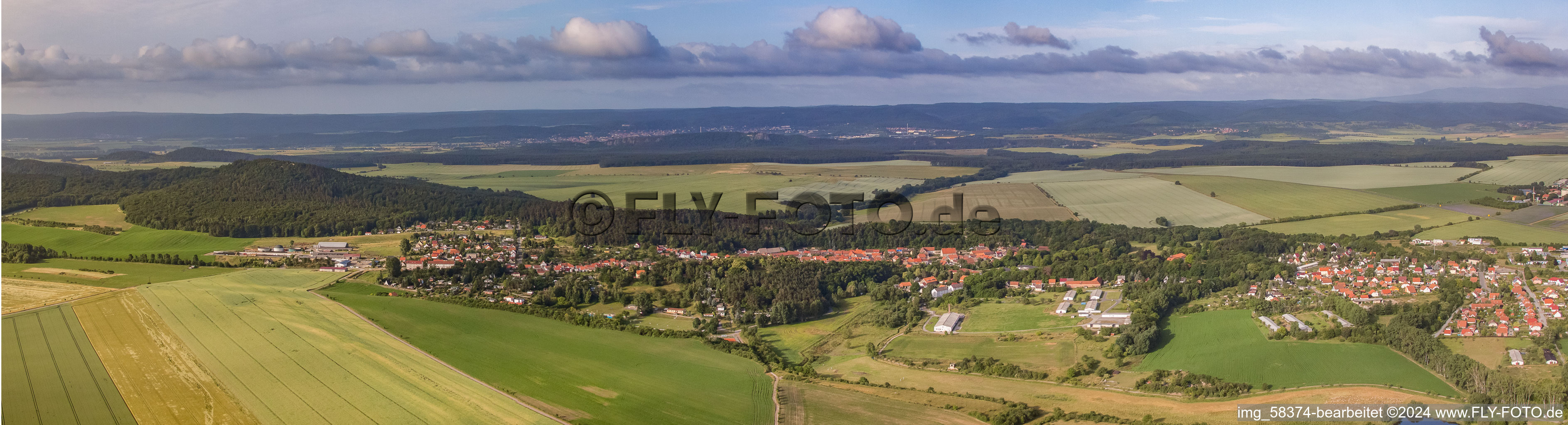 Panoramic perspective Village - view on the edge of agricultural fields and farmland in Langenstein in the state Saxony-Anhalt, Germany