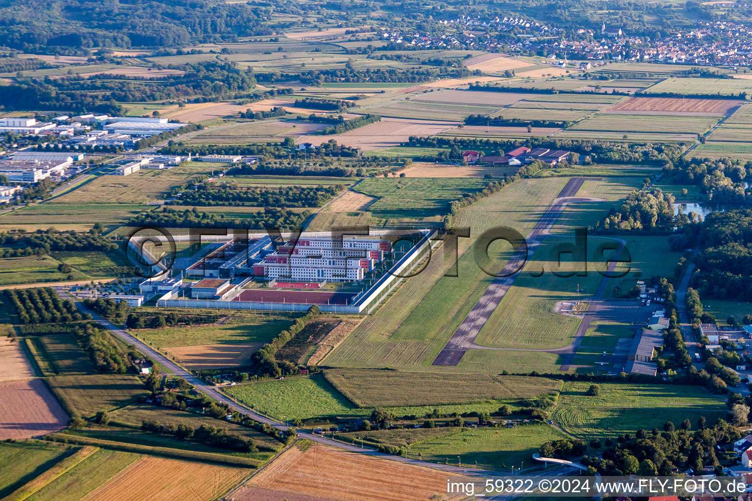 Prison grounds and high security fence Prison Justizvollzugsanstalt Offenburg on Flugplatz Offenburg-Baden in Offenburg in the state Baden-Wurttemberg, Germany