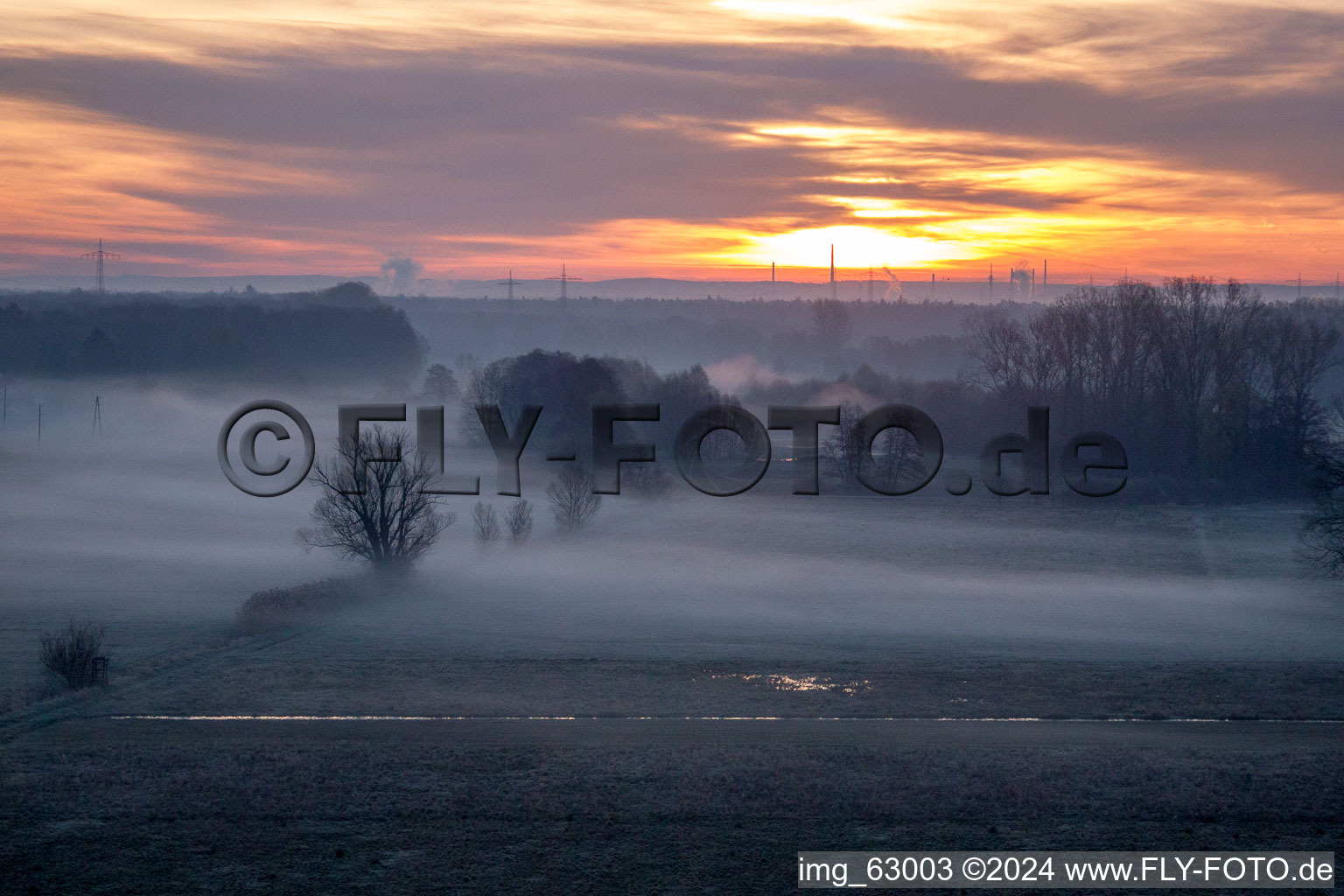 Colorful sunrise over the countryside in Minfeld in the state Rhineland-Palatinate dyes the sky orange and yellow