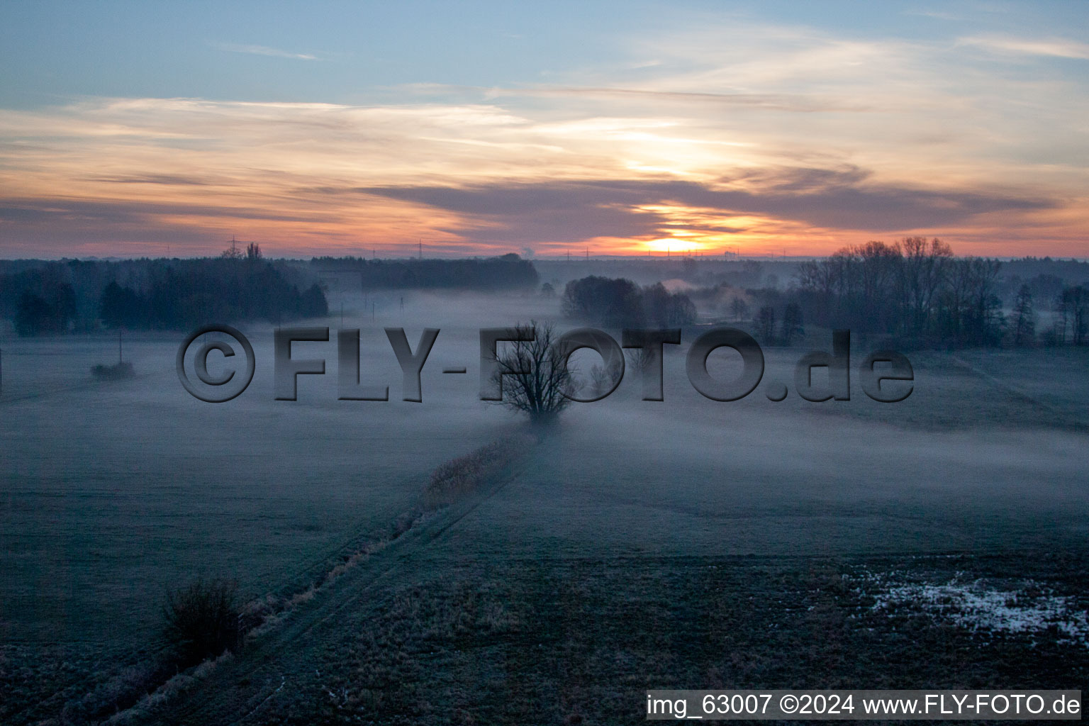 Aerial view of Colorful sunrise over the countryside in Minfeld in the state Rhineland-Palatinate dyes the sky orange and yellow