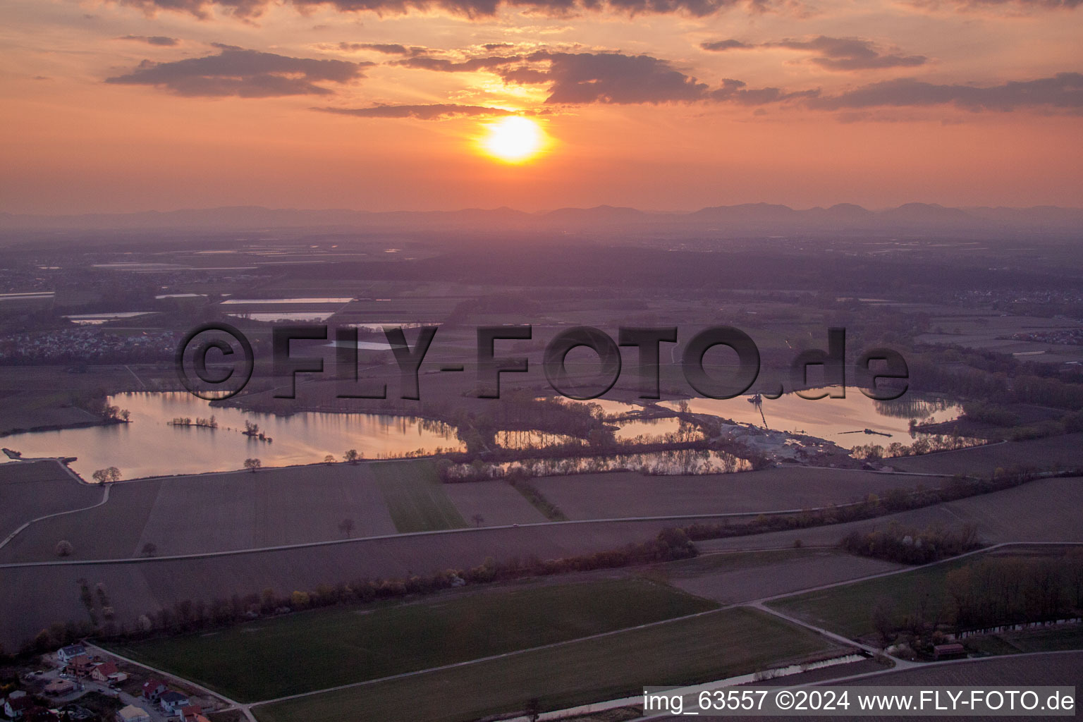 Colorful sunset over the countryside in Neupotz in the state Rhineland-Palatinate dyes the sky purple and orange