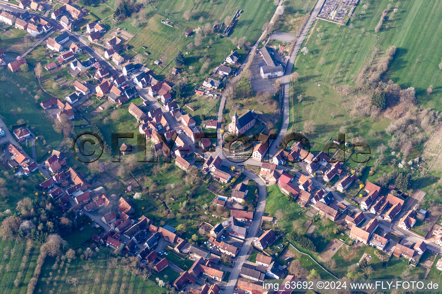 Aerial view of Village - view on the edge of agricultural fields and farmland in Langensoultzbach in Grand Est, France