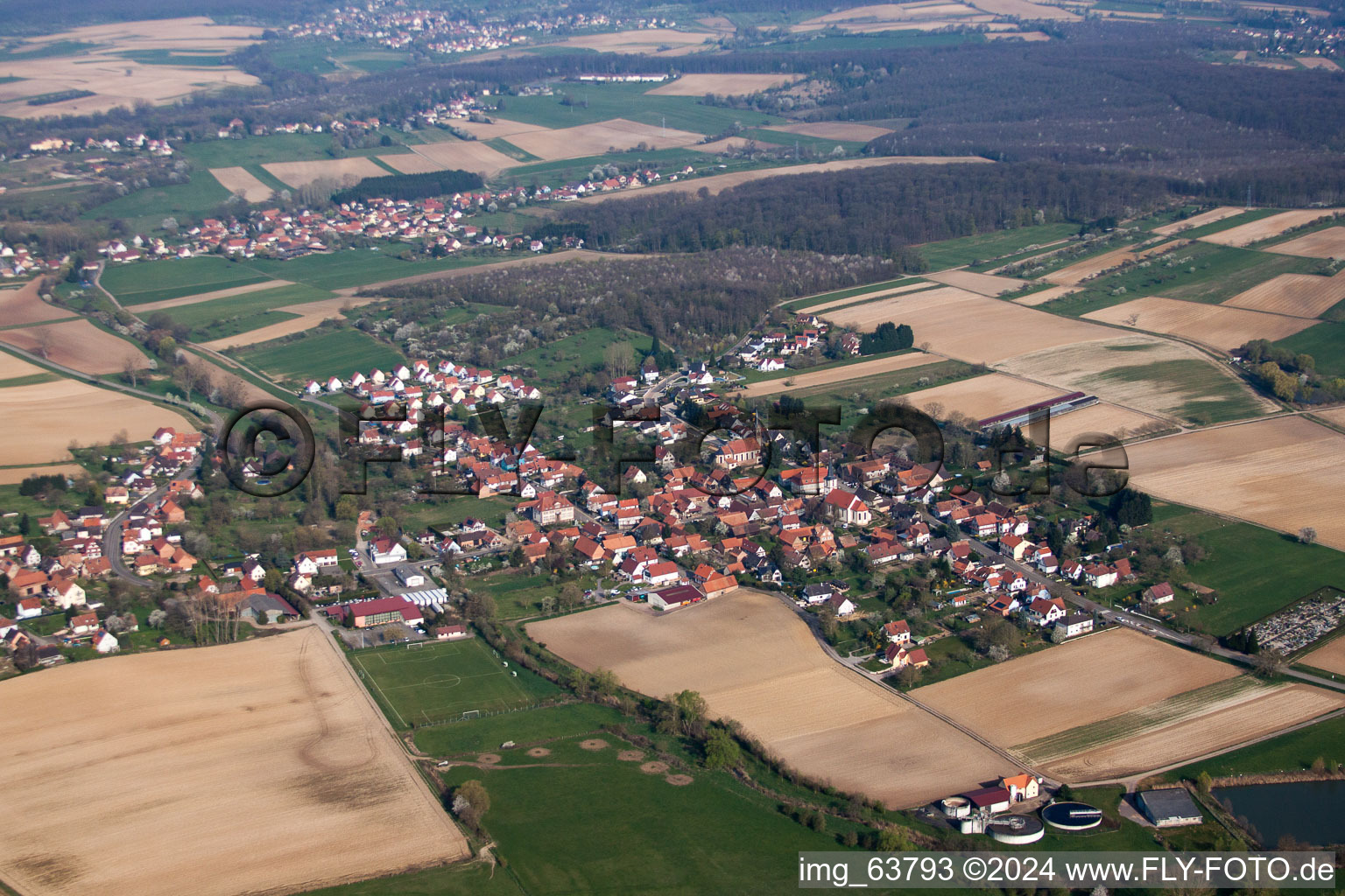 Aerial photograpy of Village - view on the edge of agricultural fields and farmland in Kutzenhausen in Grand Est, France