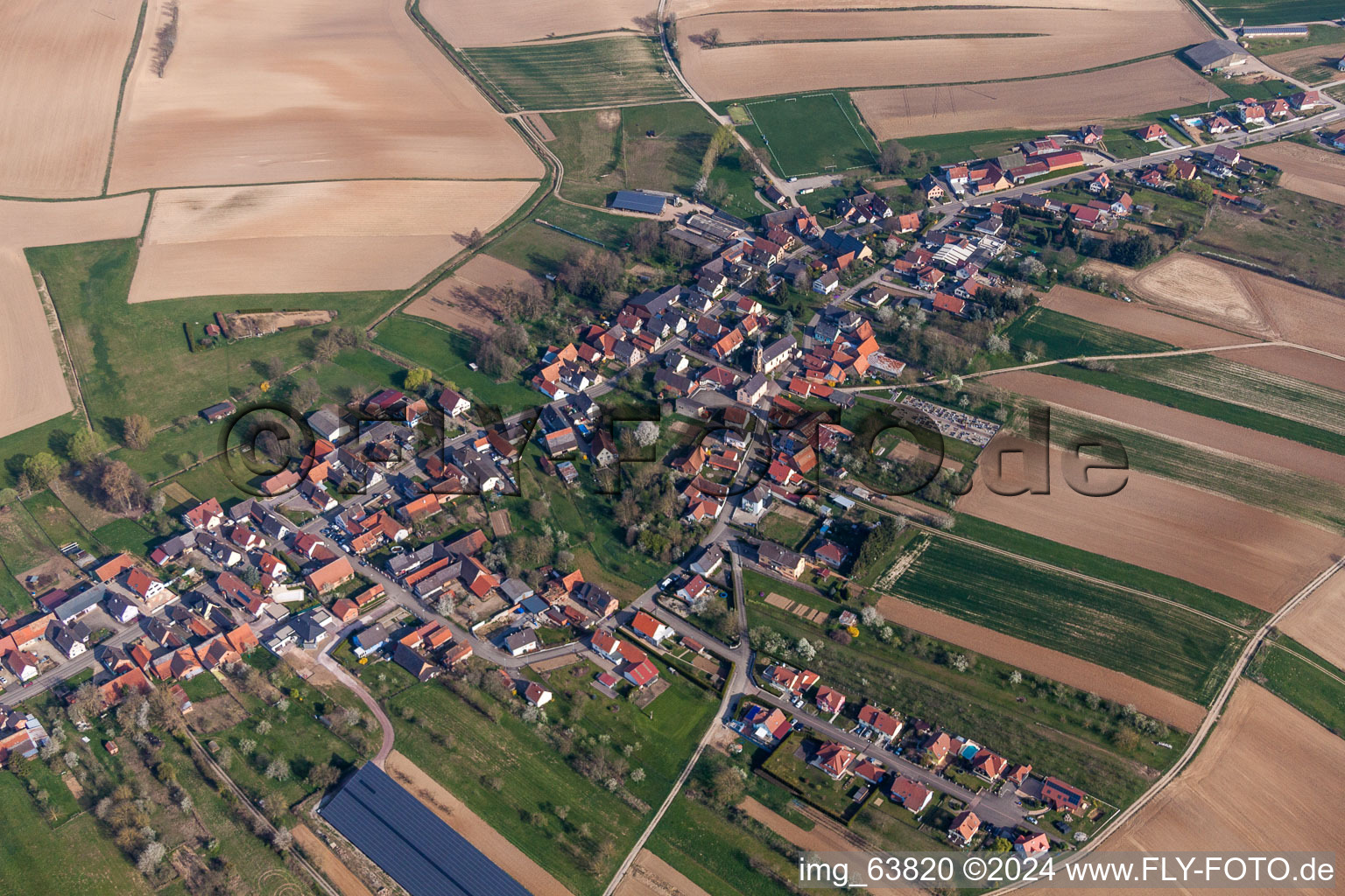 Aerial photograpy of Village - view on the edge of agricultural fields and farmland in Siegen in Grand Est, France