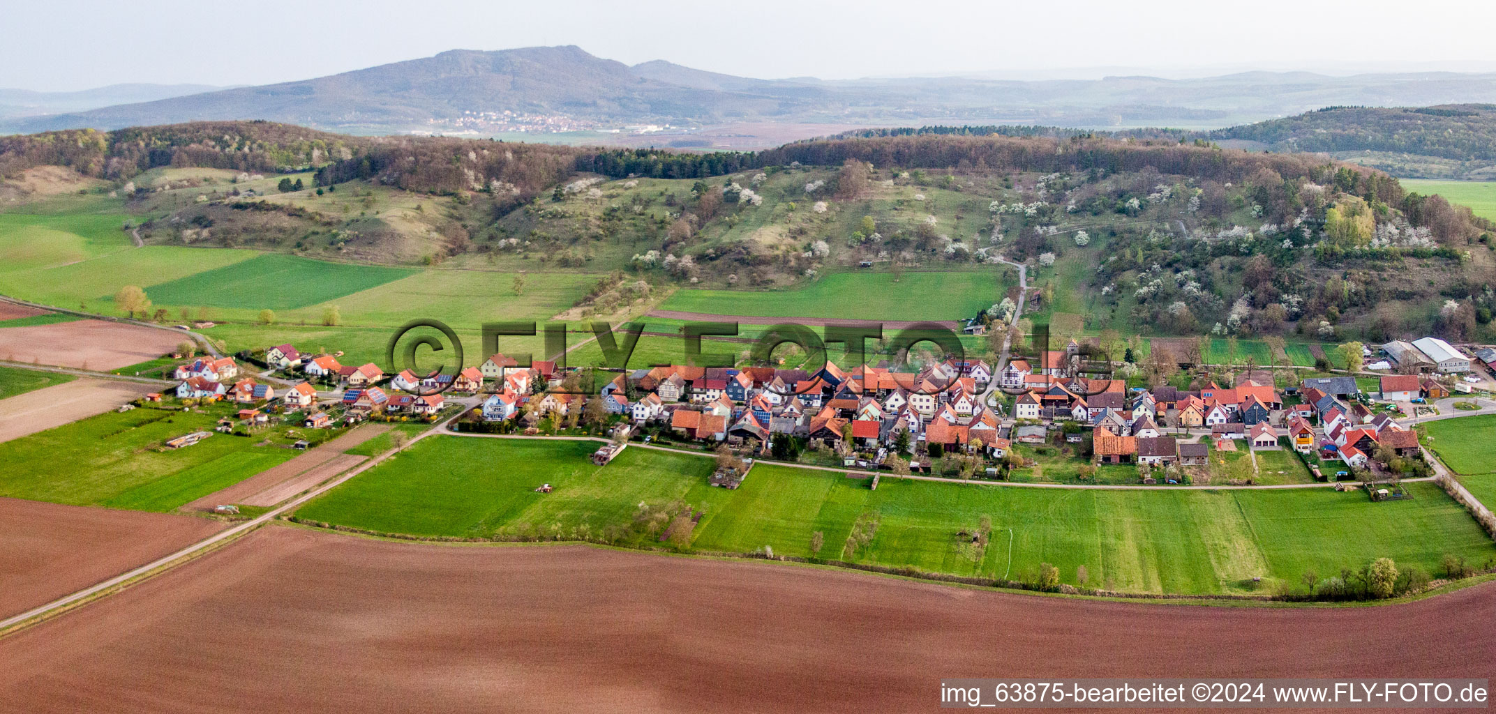 Village - view on the edge of agricultural fields and farmland in Schlechtsart in the state Thuringia, Germany