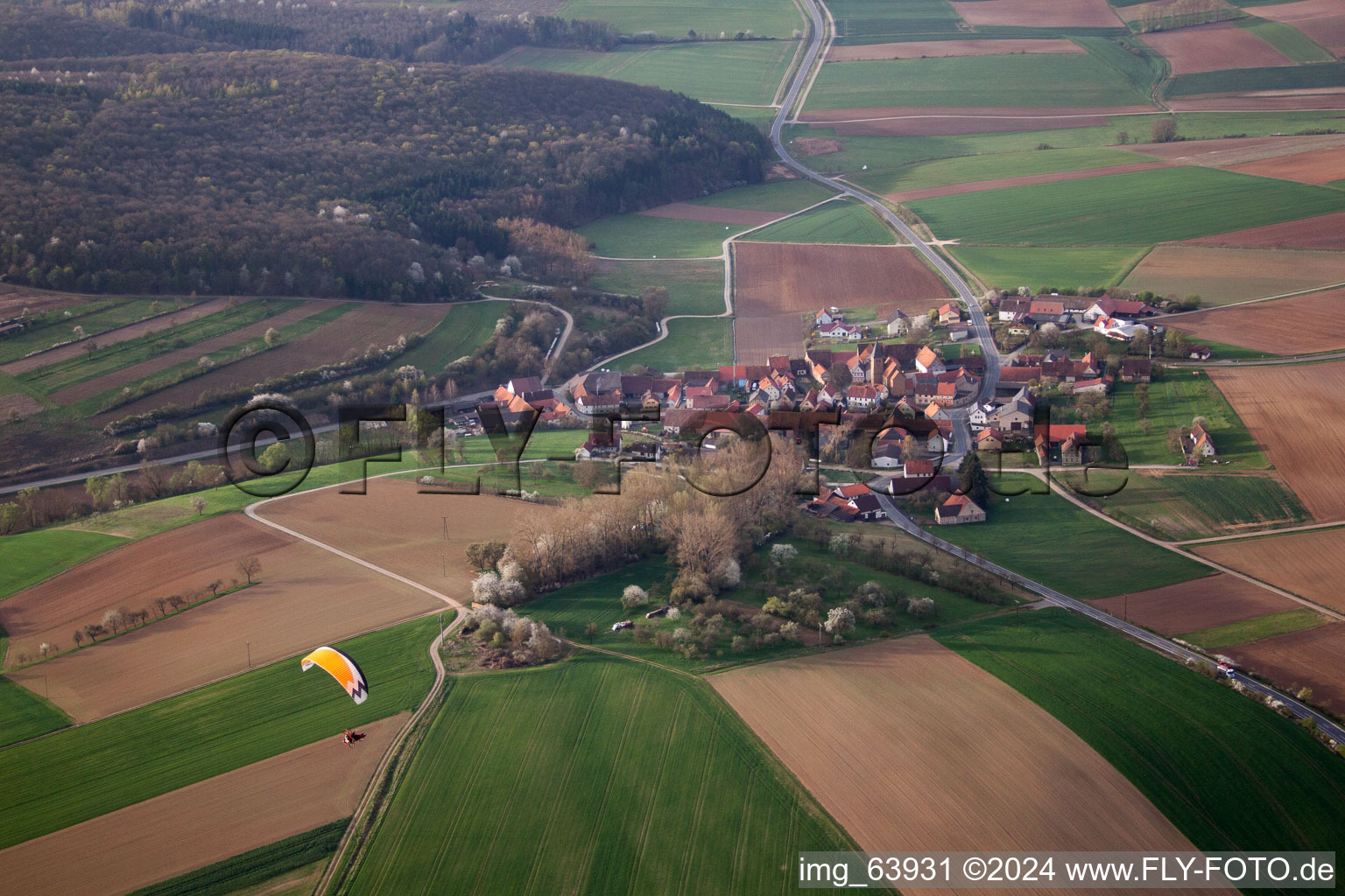 Village - view on the edge of agricultural fields and farmland in Junkershausen in the state Bavaria, Germany