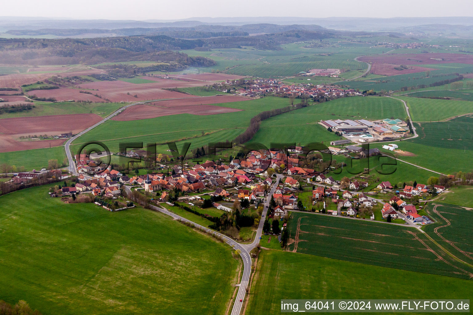 Village - view on the edge of agricultural fields and farmland in Simmershausen in the state Thuringia, Germany