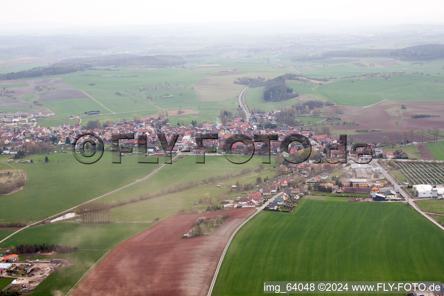 Village - view on the edge of agricultural fields and farmland in Straufhain in the state Thuringia, Germany