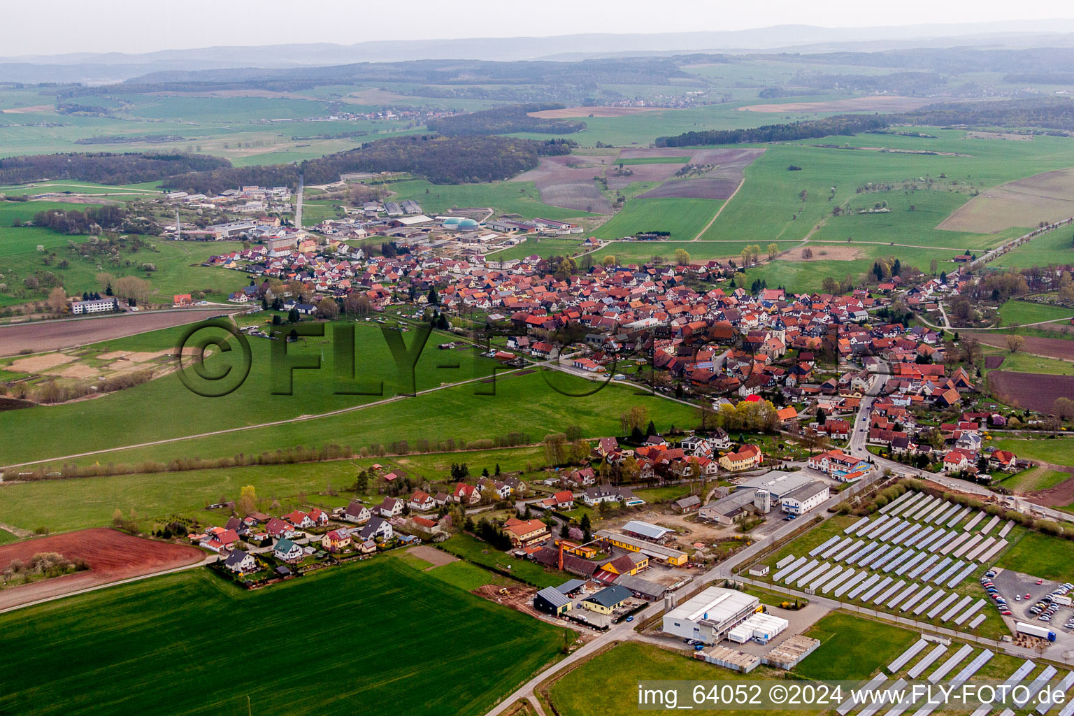 Oblique view of Village - view on the edge of agricultural fields and farmland in Straufhain in the state Thuringia, Germany
