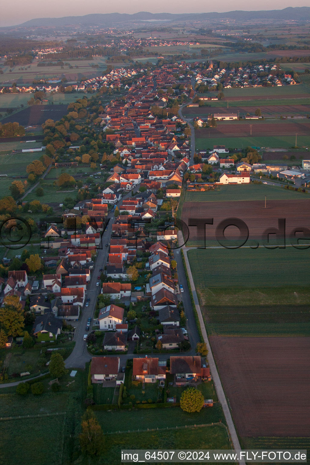 Village - view on the edge of agricultural fields and farmland in Freckenfeld in the state Rhineland-Palatinate, Germany from above