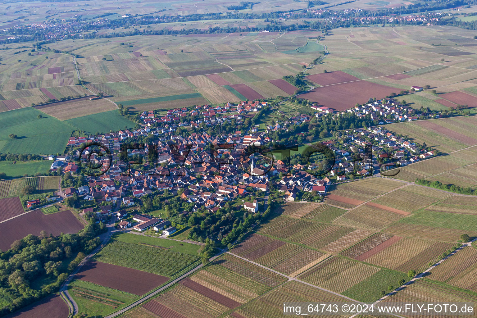 Aerial view of Village - view on the edge of agricultural fields and farmland in Wollmesheim in the state Rhineland-Palatinate, Germany