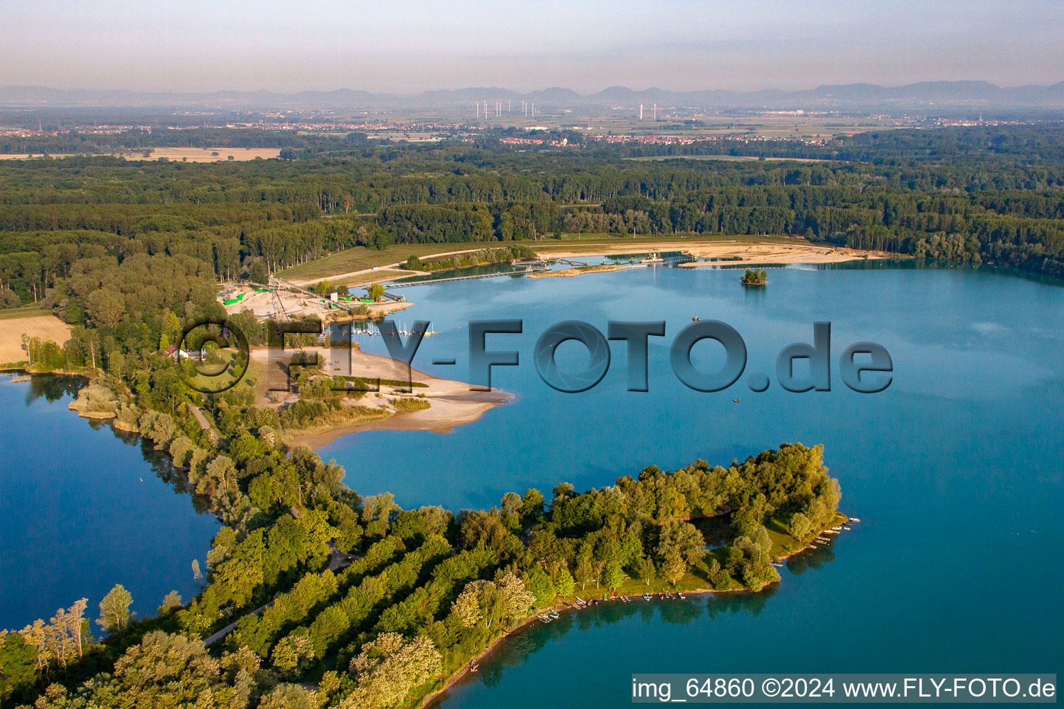 Aerial view of Fisherman's home, beach and Heidelberg Materials Mineralik at the Giessen quarry lake in the district Liedolsheim in Dettenheim in the state Baden-Wuerttemberg, Germany