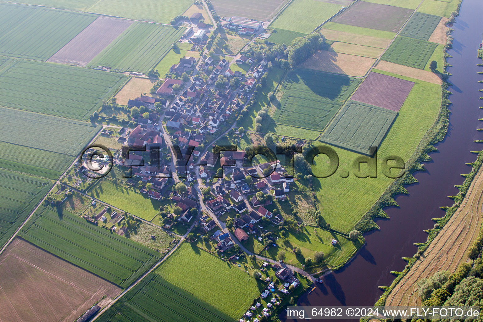 Aerial view of Village on the river bank areas of the Weser river in Brevoerde in the state Lower Saxony, Germany