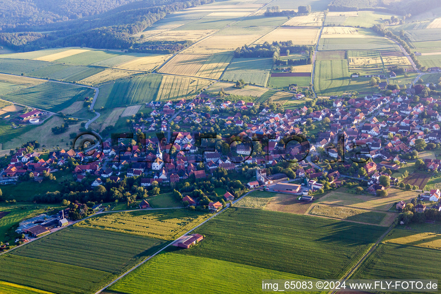 Village - view on the edge of agricultural fields and farmland in Ottenstein in the state Lower Saxony, Germany