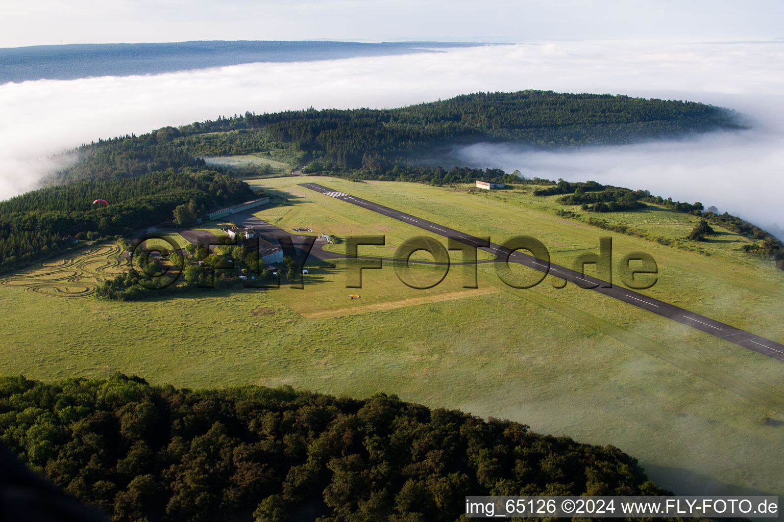 Aerial view of Runway with tarmac terrain of airfield Hoexter-Holzminden with morning mist in the district Brenkhausen in Hoexter in the state North Rhine-Westphalia, Germany