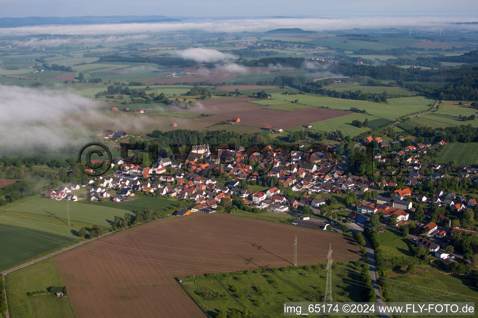 Village - view on the edge of agricultural fields and farmland in Marienmuenster in the state North Rhine-Westphalia, Germany