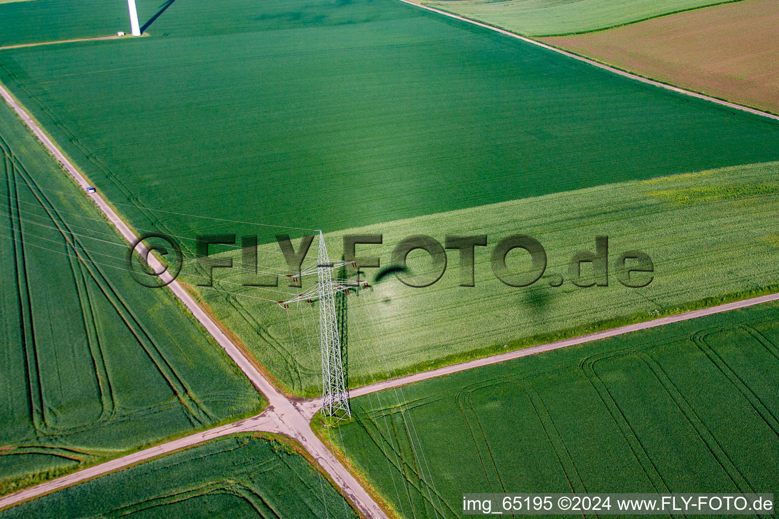 Aerial photograpy of Shadow of paraglider next to high voltage pylon in the district Bredenborn in Marienmünster in the state North Rhine-Westphalia, Germany