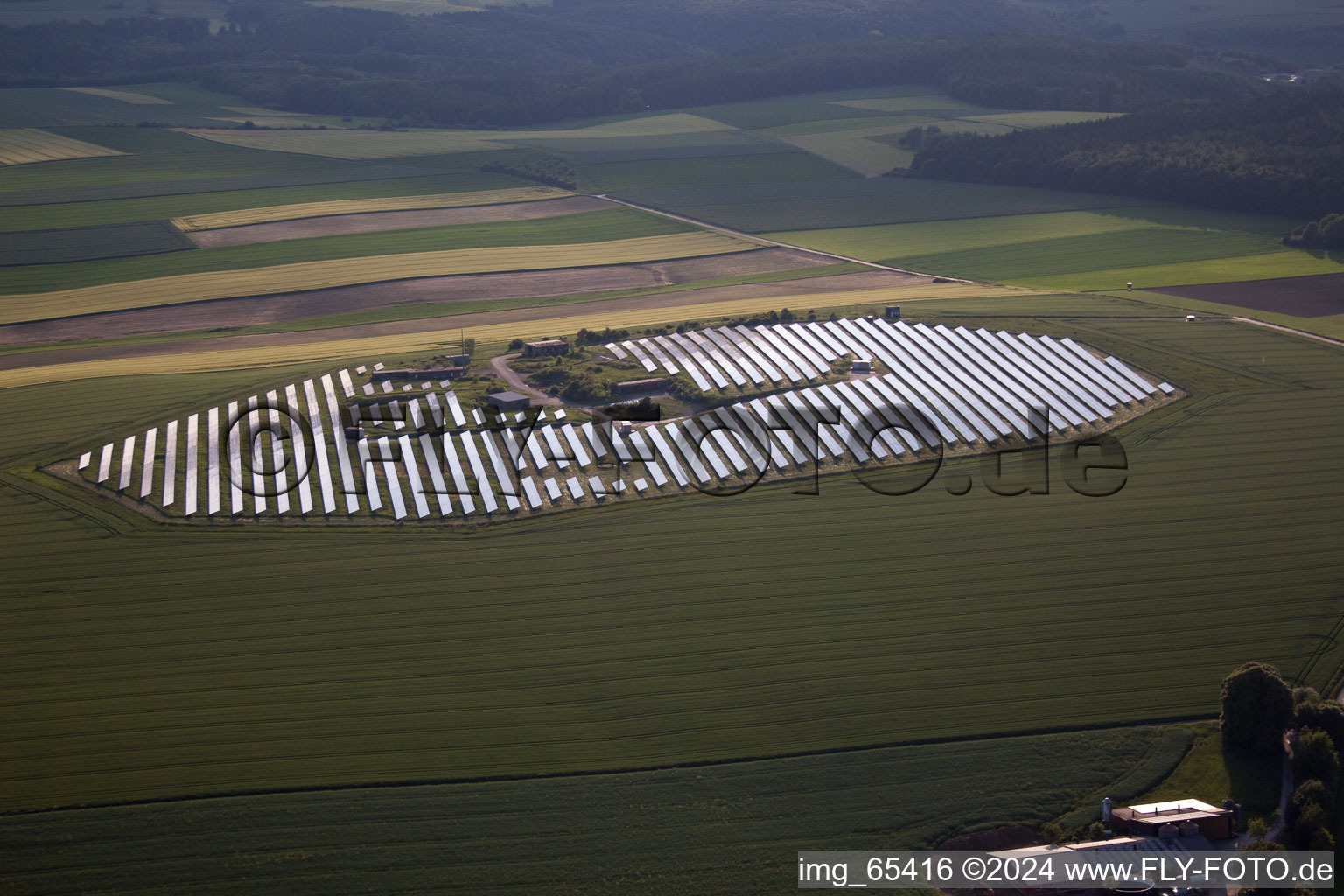 Aerial view of Panel rows of photovoltaic and solar farm or solar power plant in Beverungen in the state North Rhine-Westphalia