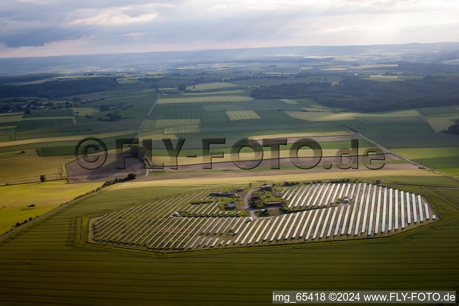 Aerial photograpy of Panel rows of photovoltaic and solar farm or solar power plant in Beverungen in the state North Rhine-Westphalia