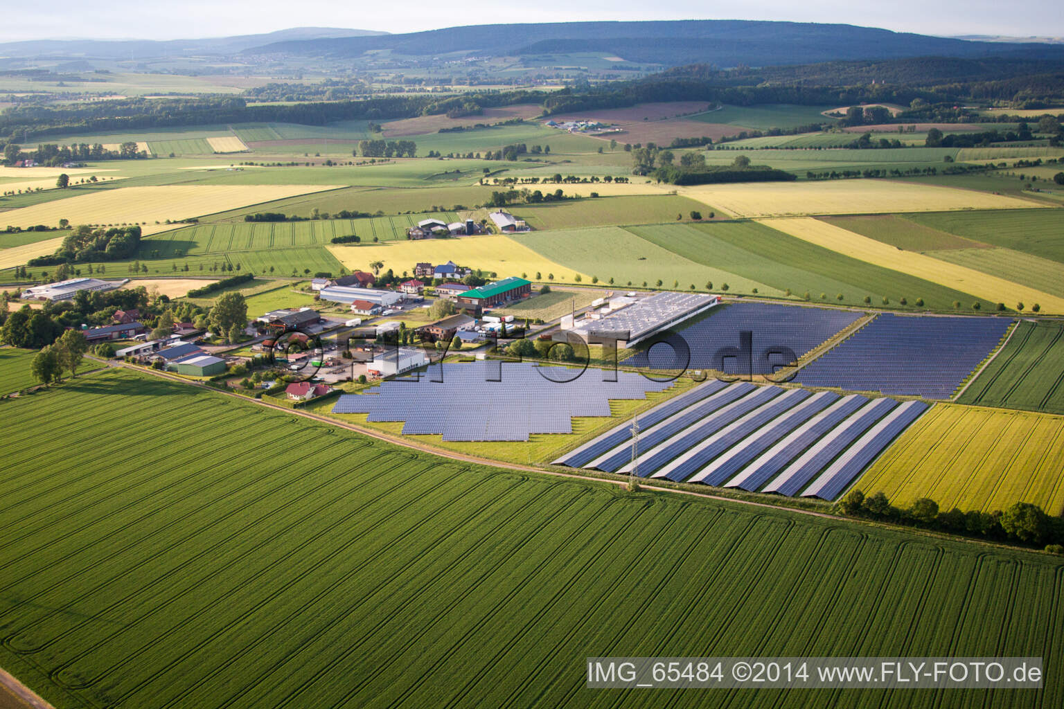 Panel rows of photovoltaic and solar farm or solar power plant in the district Bredenborn in Marienmuenster in the state North Rhine-Westphalia