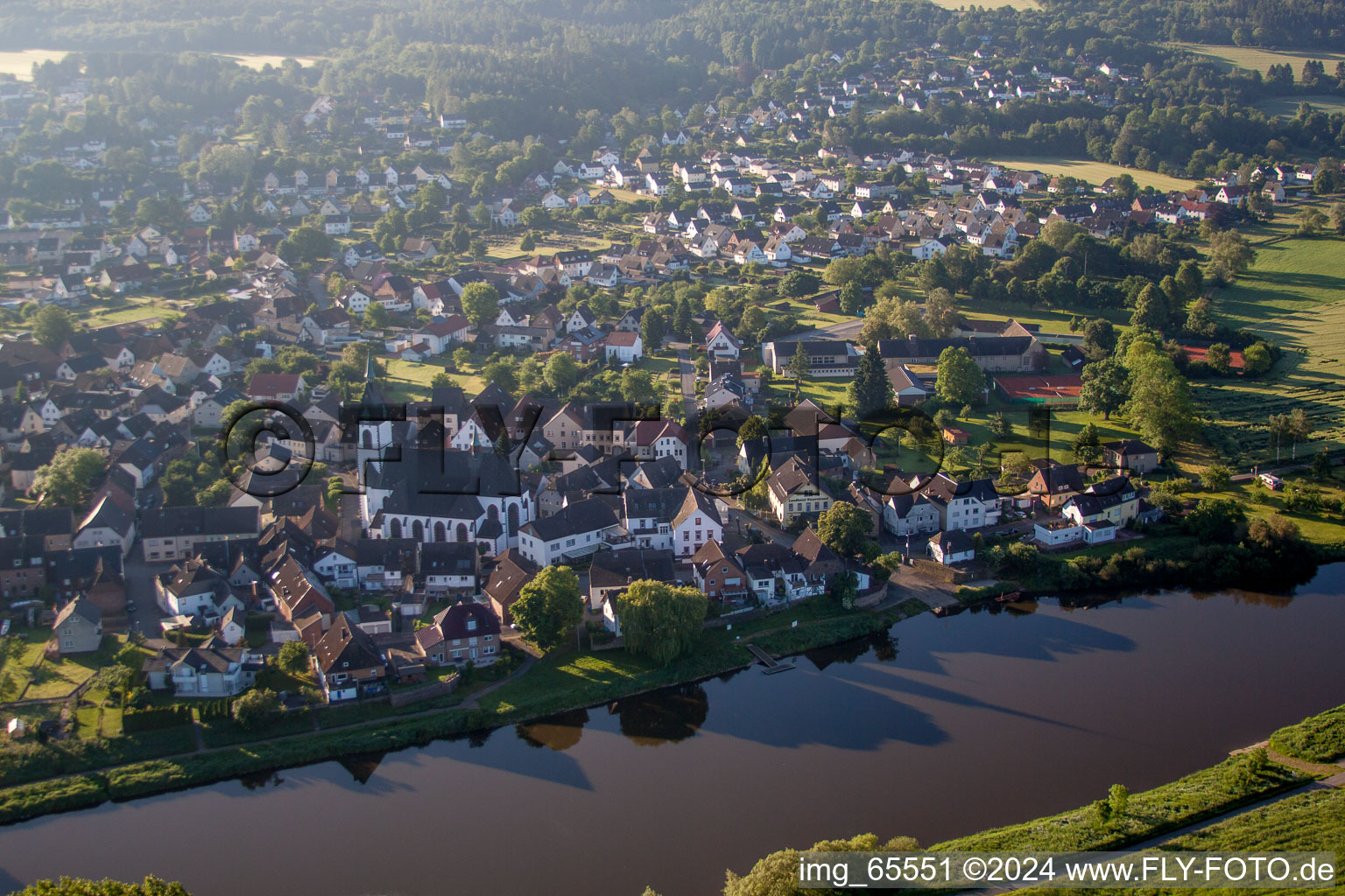 Aerial view of Town on the banks of the river of the Weser river in the district Luechtringen in Hoexter in the state North Rhine-Westphalia, Germany