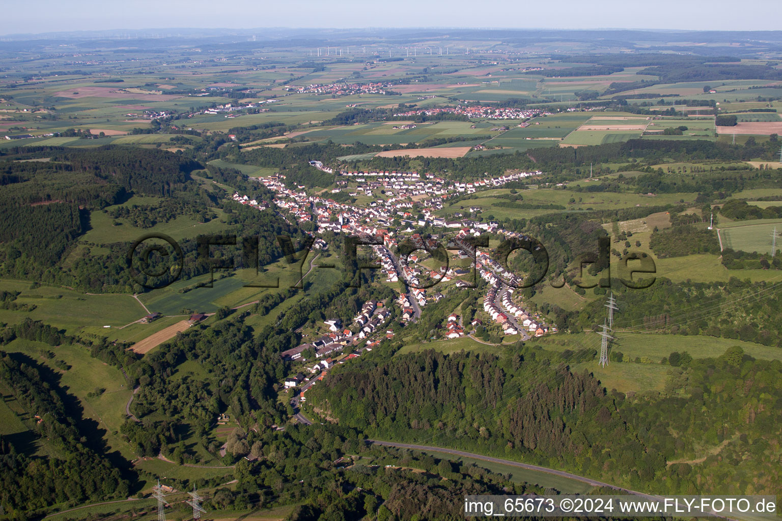 Village - view on the edge of forest, agricultural fields and farmland in the district Dalhausen in Beverungen in the state North Rhine-Westphalia, Germany
