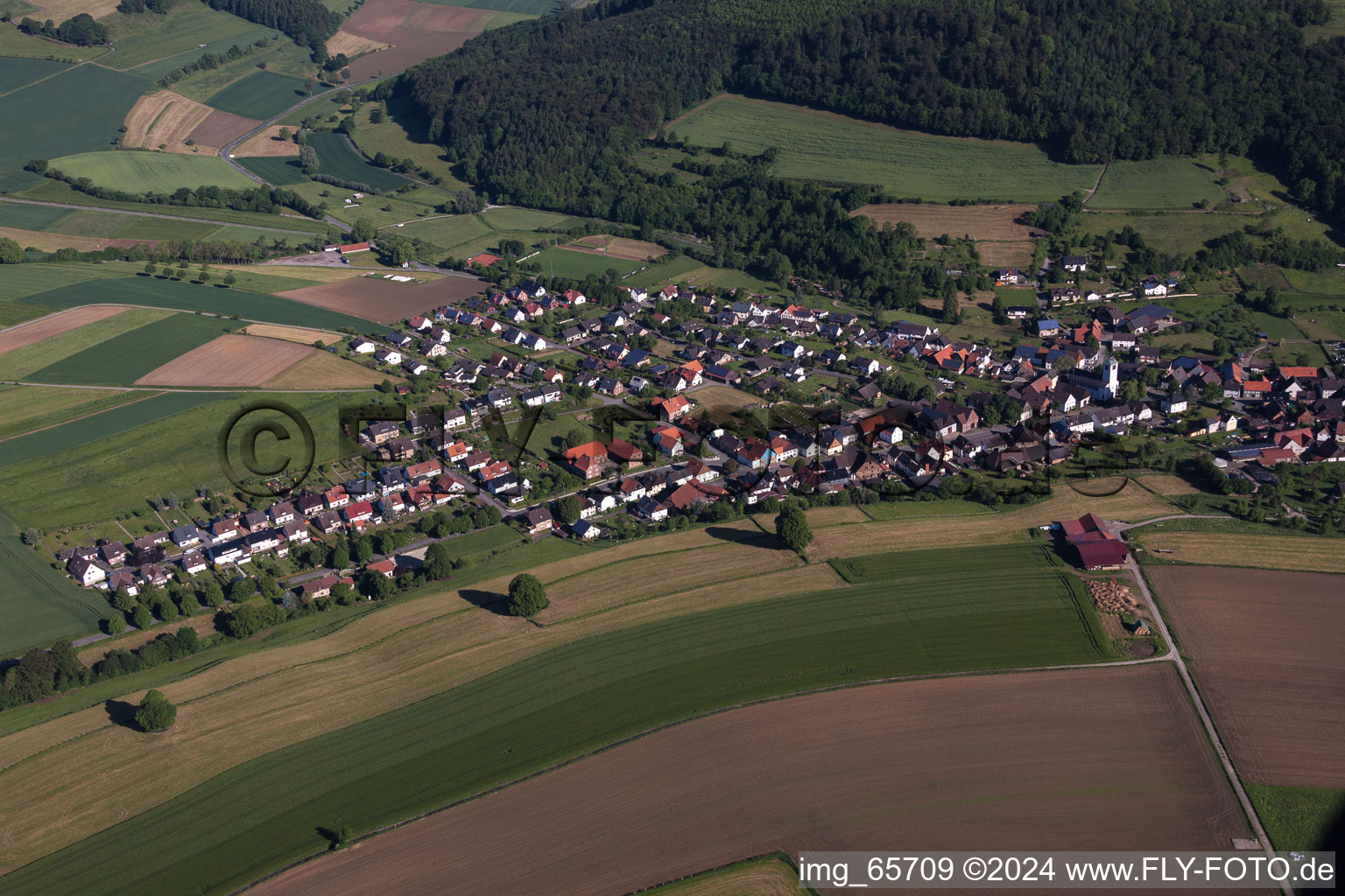 Village - view on the edge of agricultural fields and farmland in the district Ovenhausen in Hoexter in the state North Rhine-Westphalia, Germany
